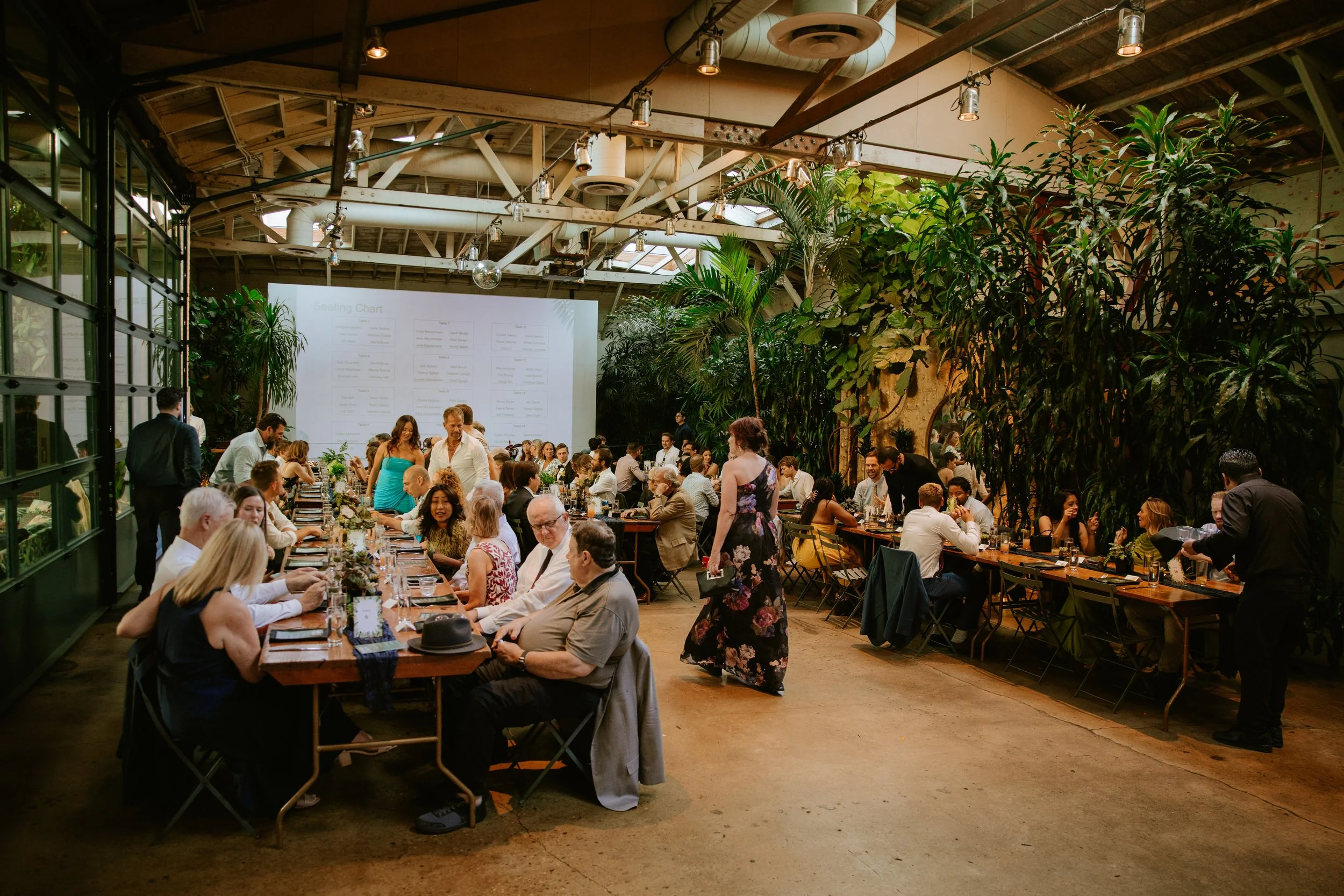 Candid photo of guests taking their seat for the wedding reception at Millwick in DTLA