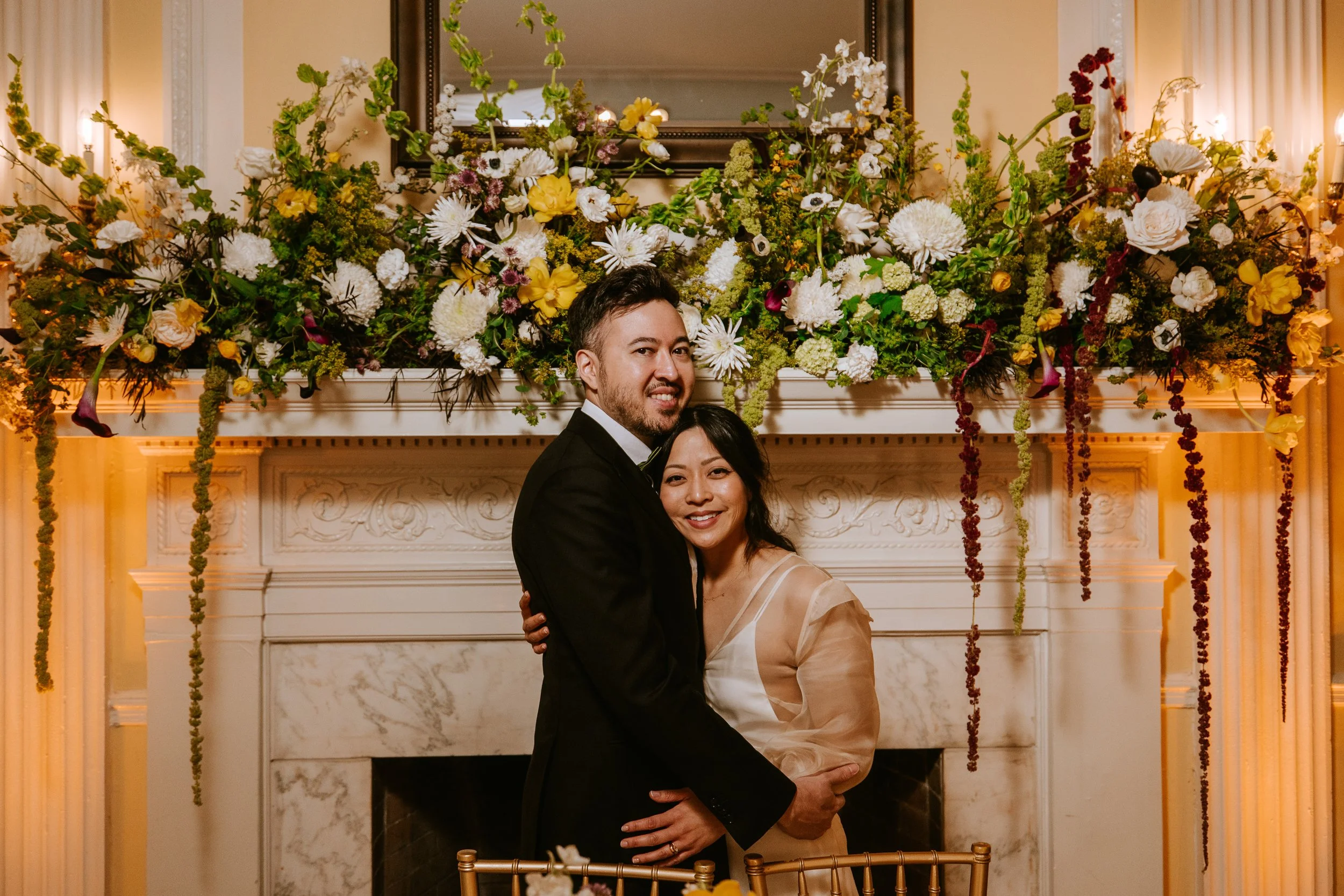 Wedding couple posing under the mantle ballroom at Josephine Butler Parks Center