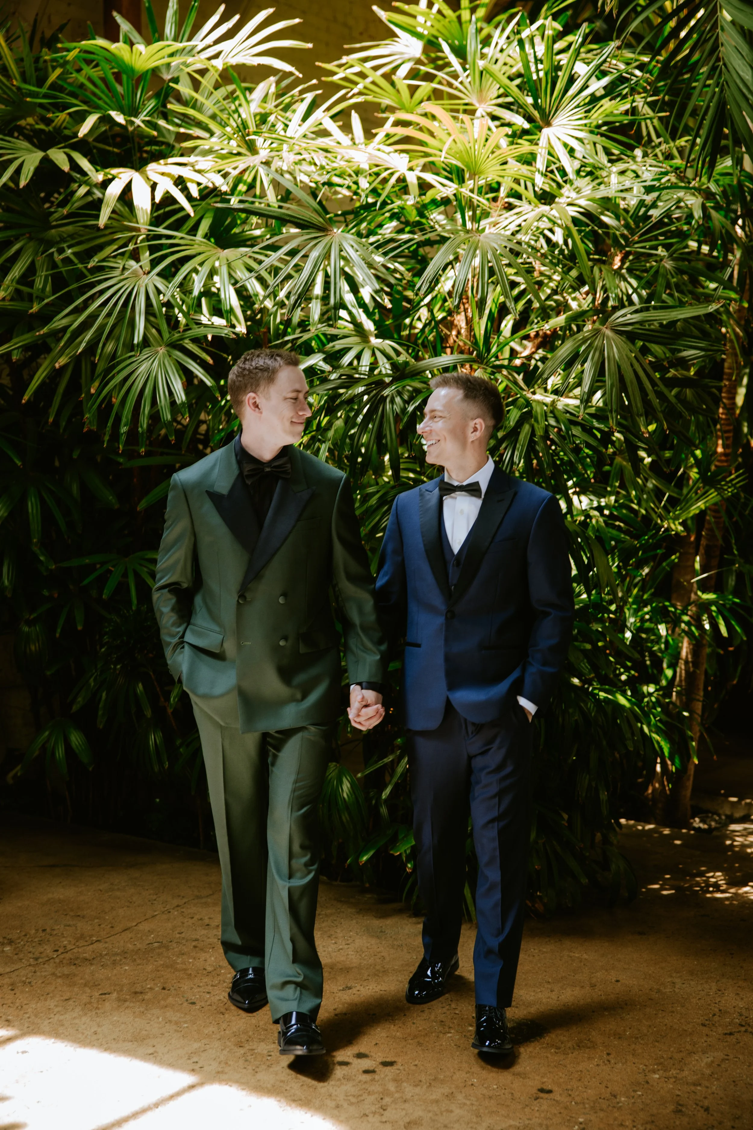 Grooms holding hands and walking at Millwick by Marvimon in DTLA