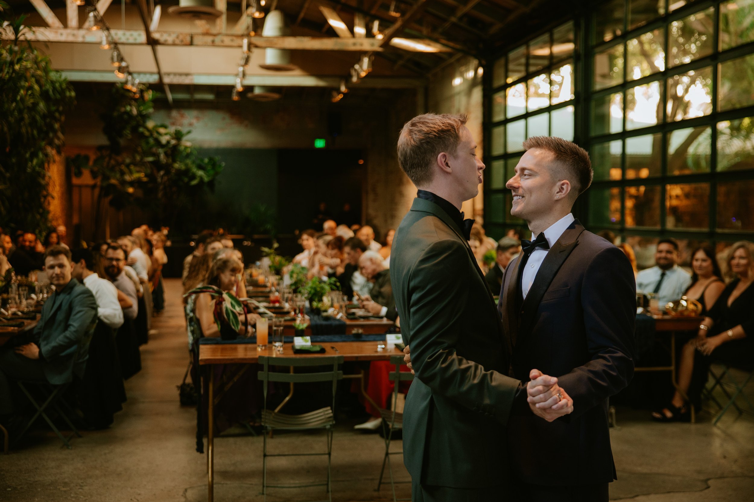 Wedding guests look upon wedding couple sharing their first dance at Millwick in DTLA