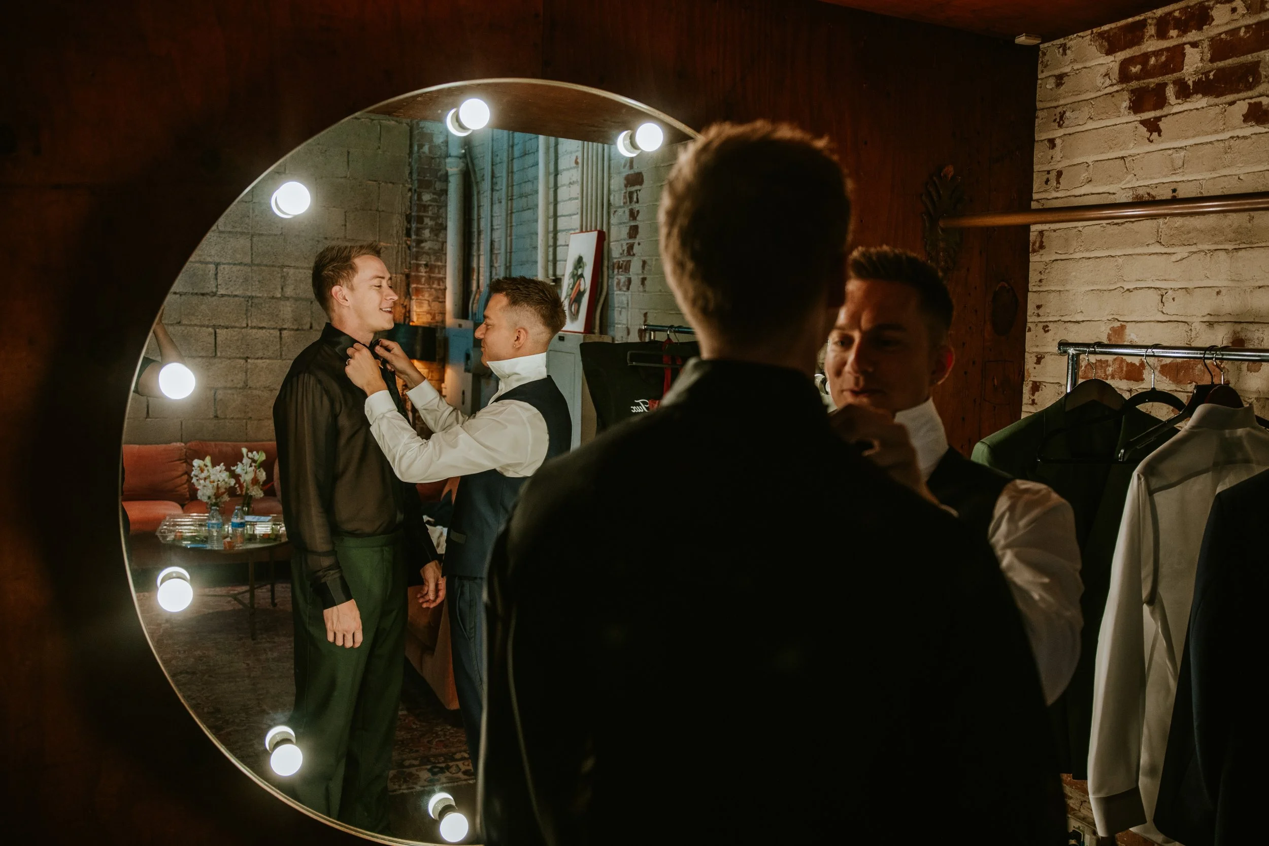 Groom fixing tie at Millwick by Marvimon in DTLA