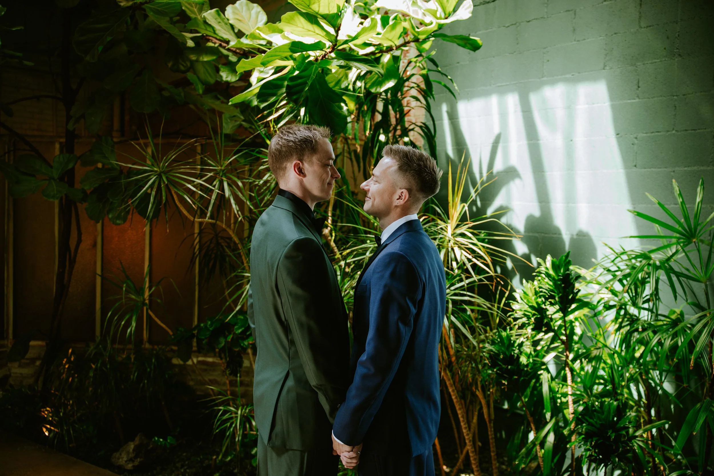 Wide shot of grooms staring into each other's eyes