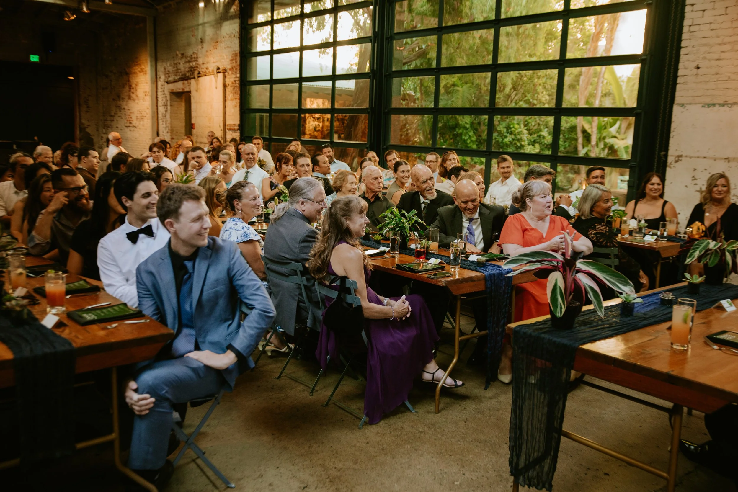 Wedding reception guests listening to toast