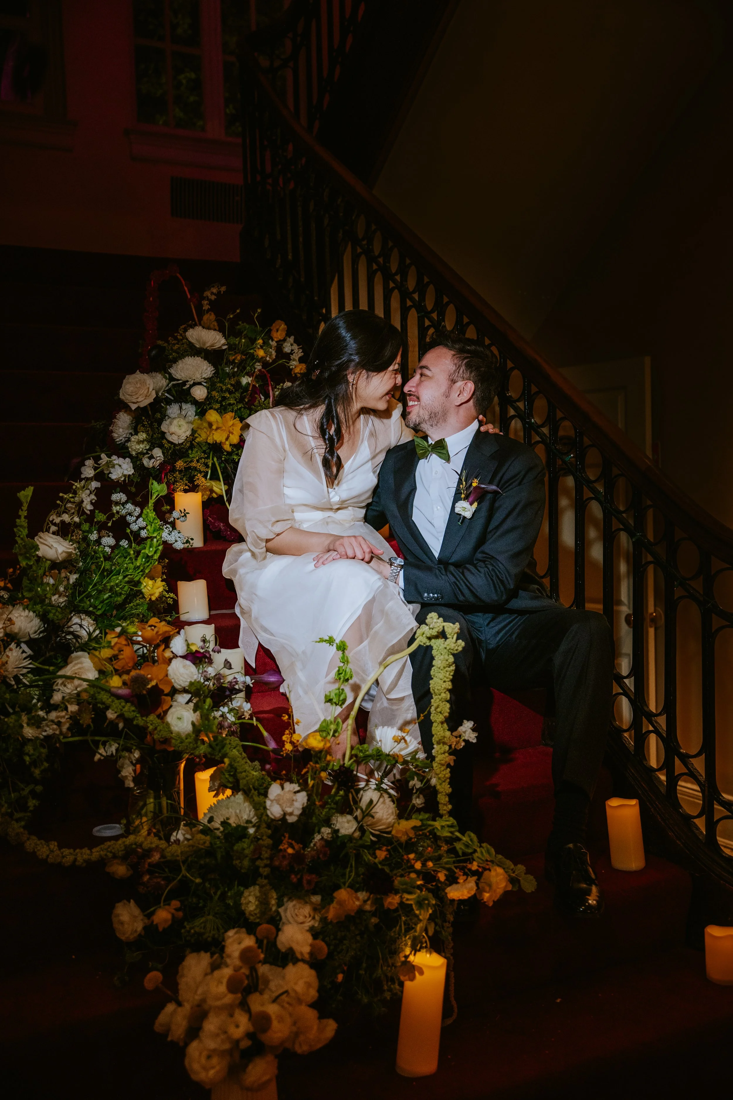 Couple sitting on staircase surrounding by flowers at Josephine Butler Parks Center