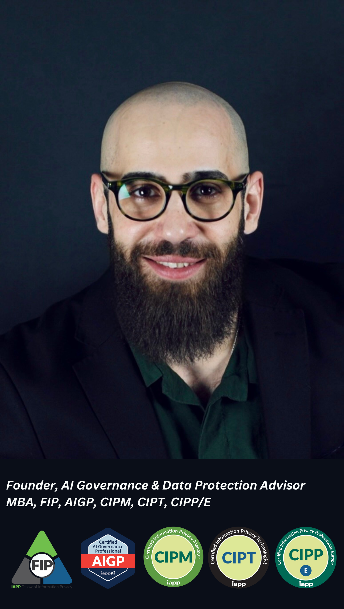 Headshot of a man with glasses and a beard, wearing a black suit jacket and a dark shirt, smiling against a dark background.