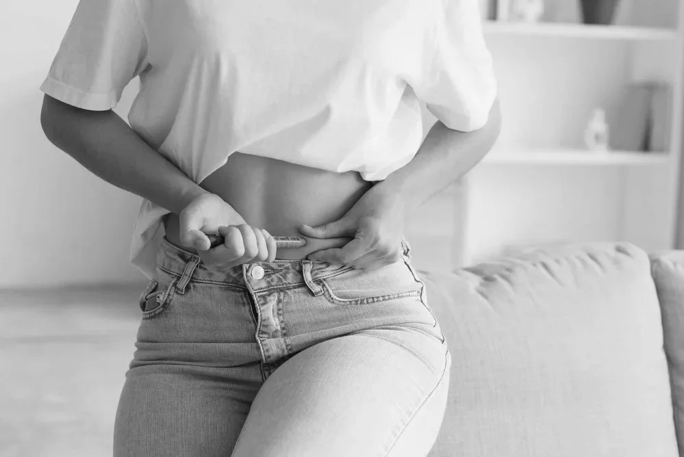 Woman’s waistline in jeans, representing medical weight loss