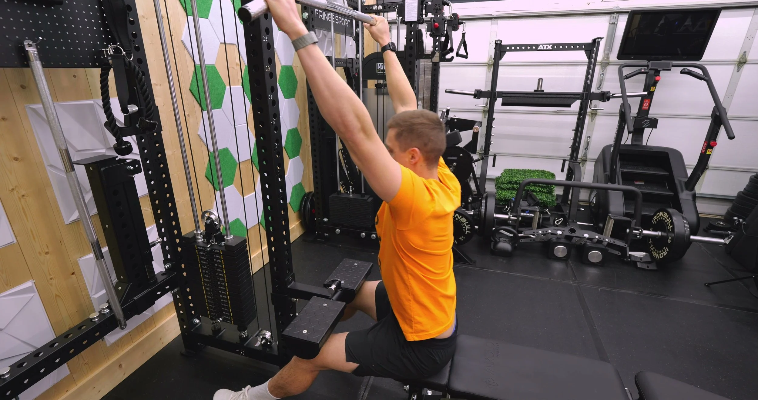 Mikolo Anubis 2.0 Elite functional trainer set up for lat pulldowns using the dual weight stacks and leg holder attachment