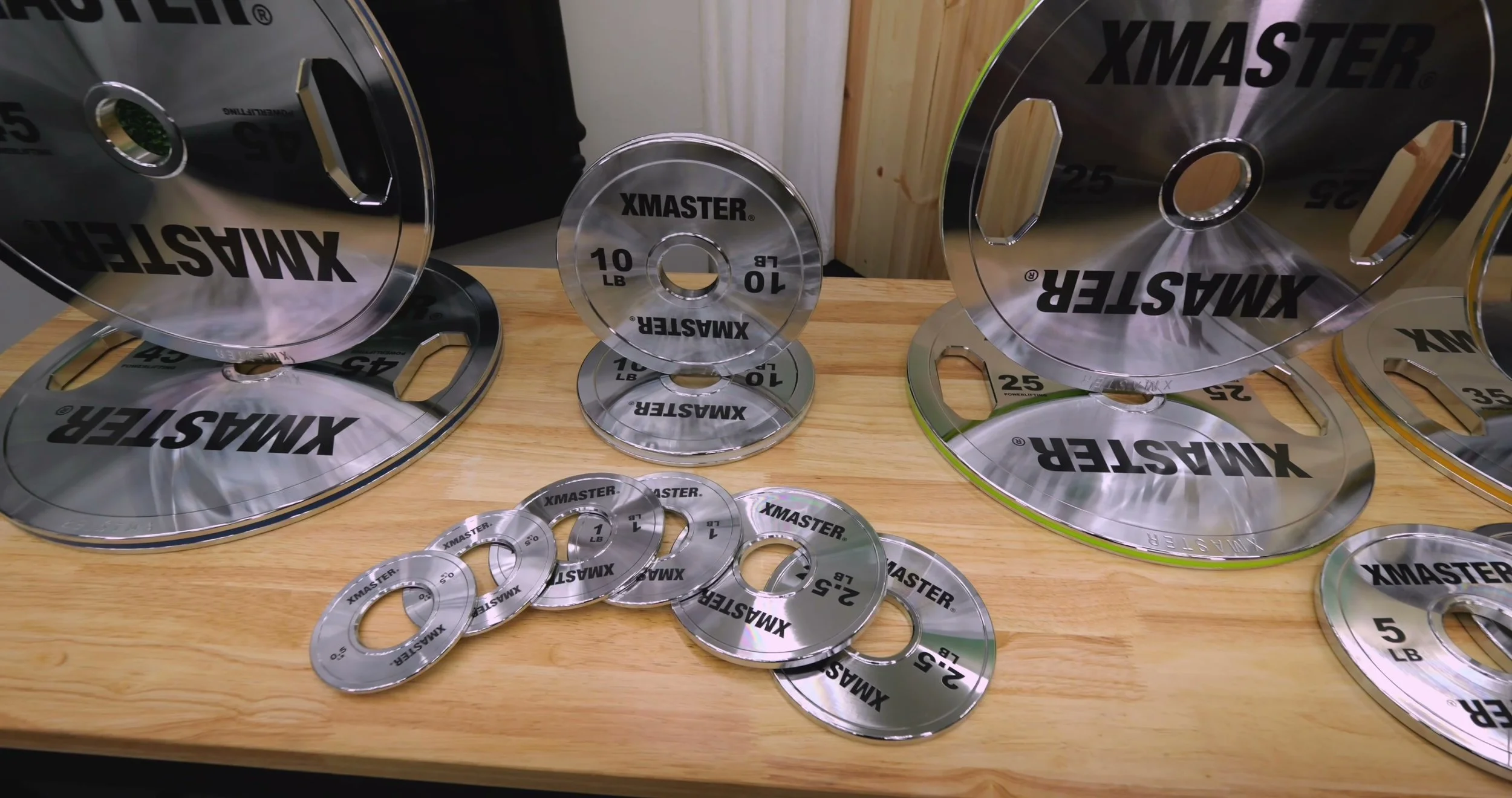 Close-up of the chrome finish, etched lettering, and color-coded edge on the XMaster 45 lb plate