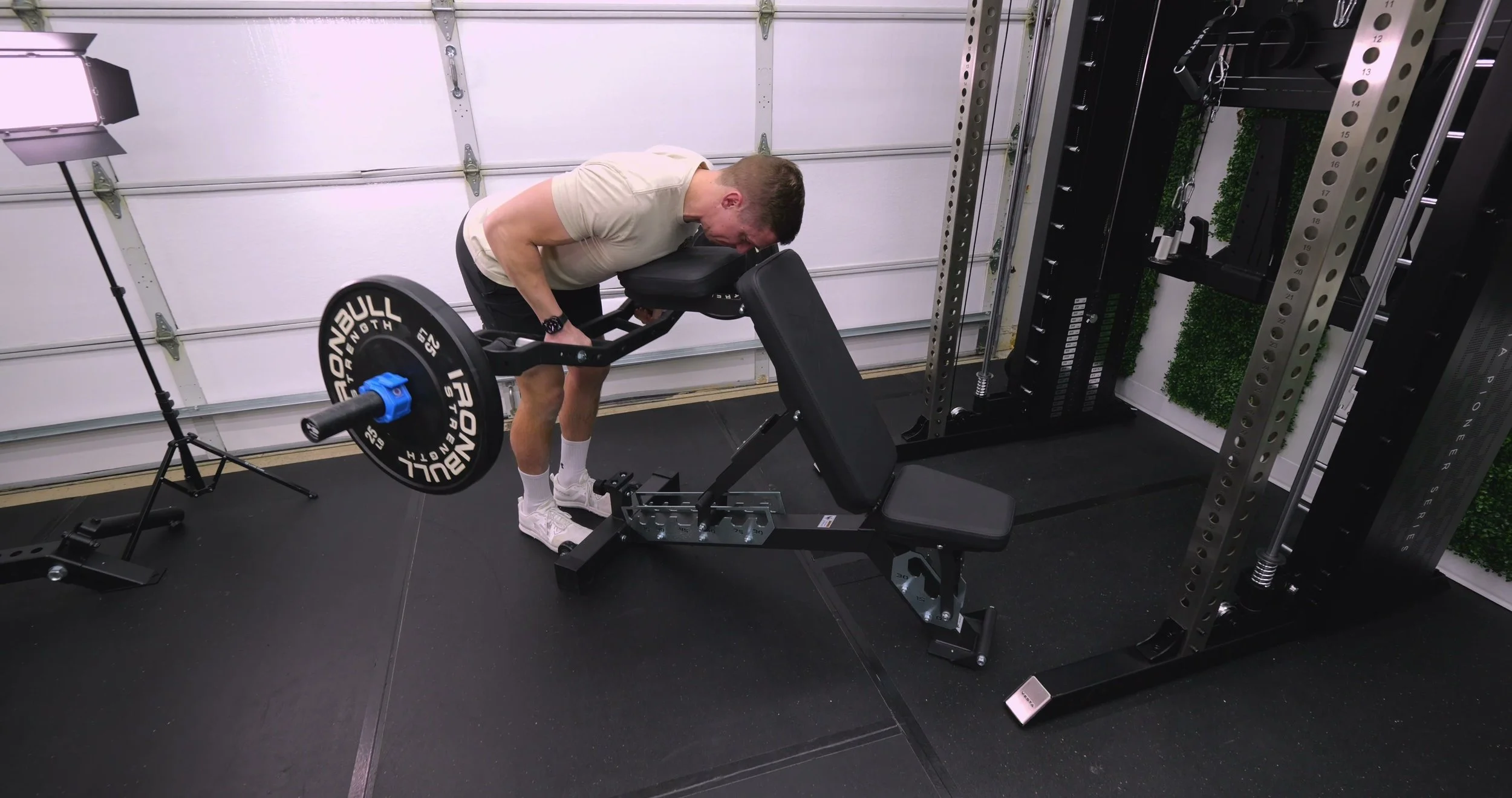 Folding chest support pad headrest on Kensui bench shown in raised position
