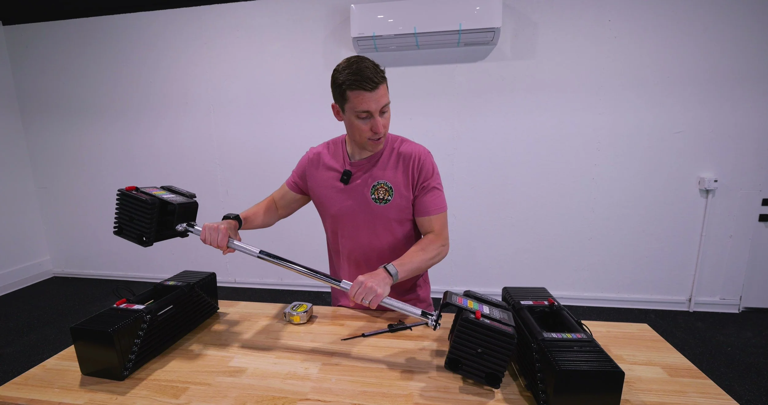 The PowerBlock straight barbell attachment loaded with the dumbbell weight stacks