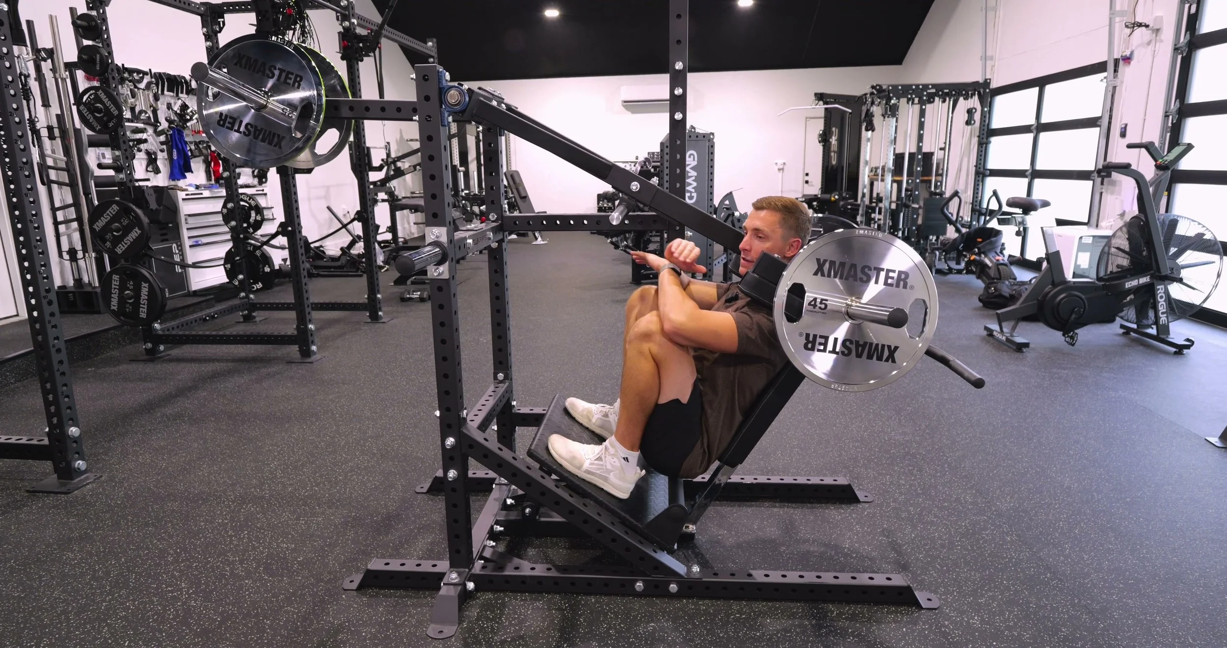Michael demonstrating the deep range of motion on the pendulum squat