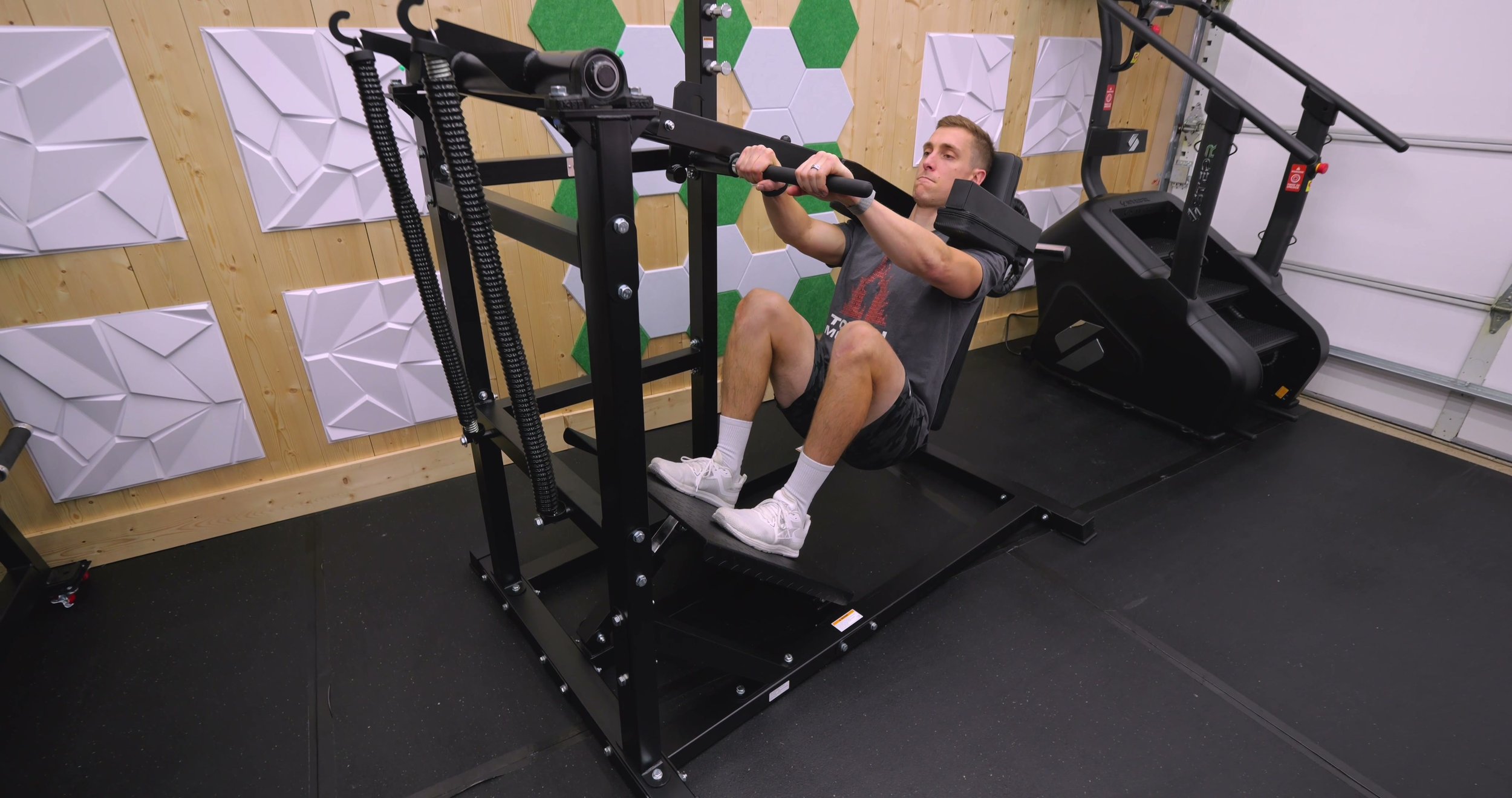 Deep bottom position of pendulum squat showing full range of motion