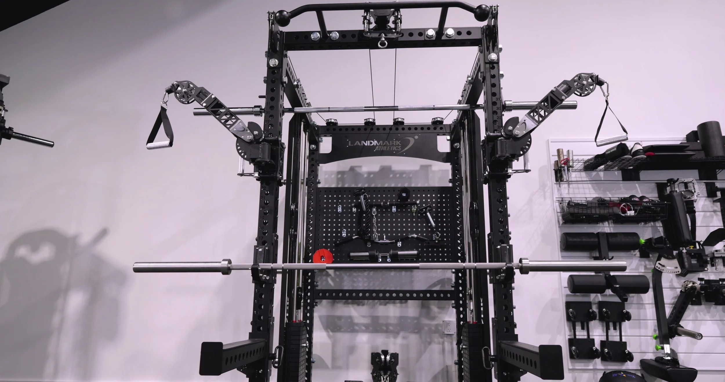 Close-up of the articulating functional trainer arms showing the adjustment pop pins