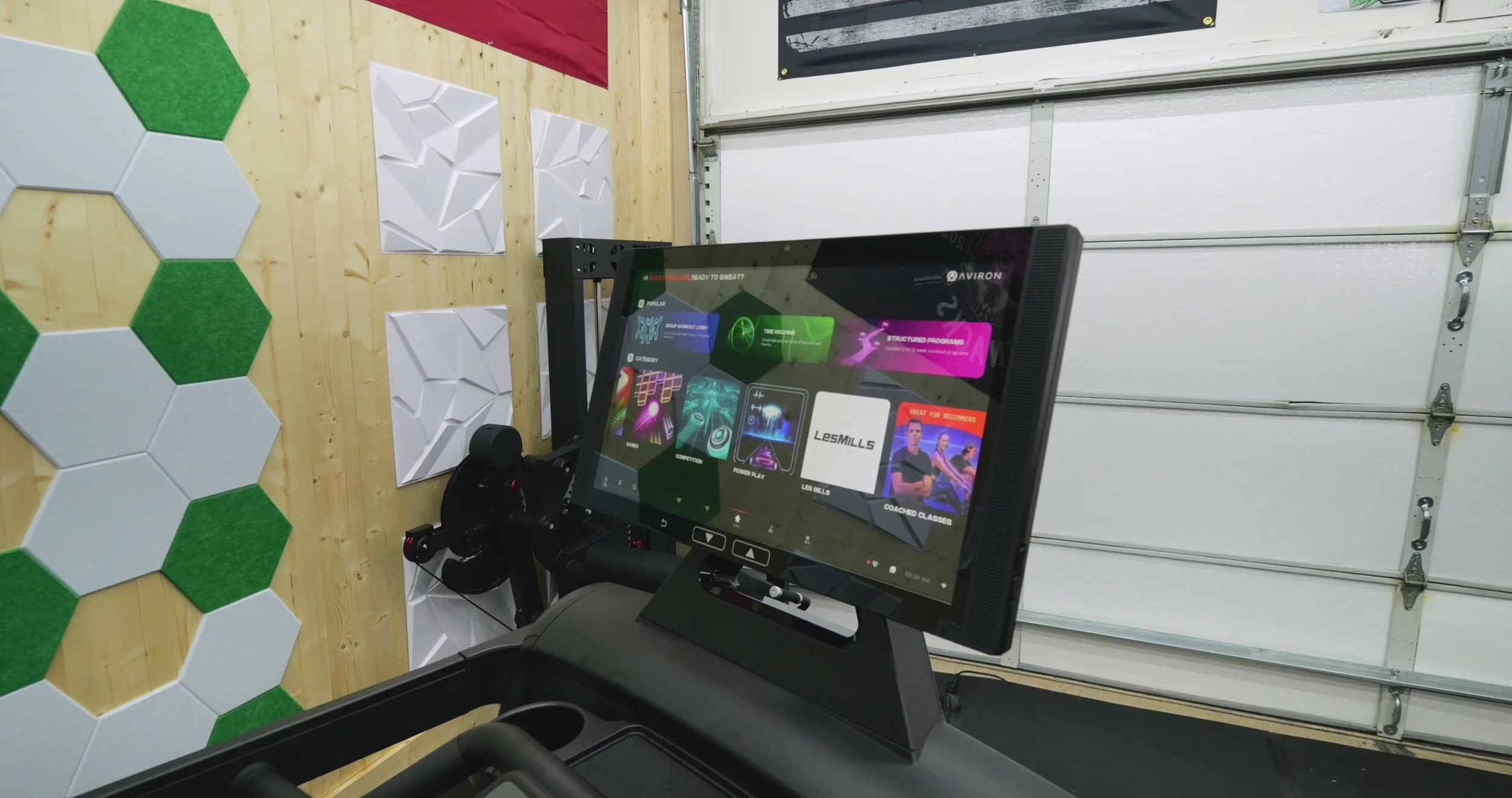 Aviron Victory touchscreen showing workout interface and metrics