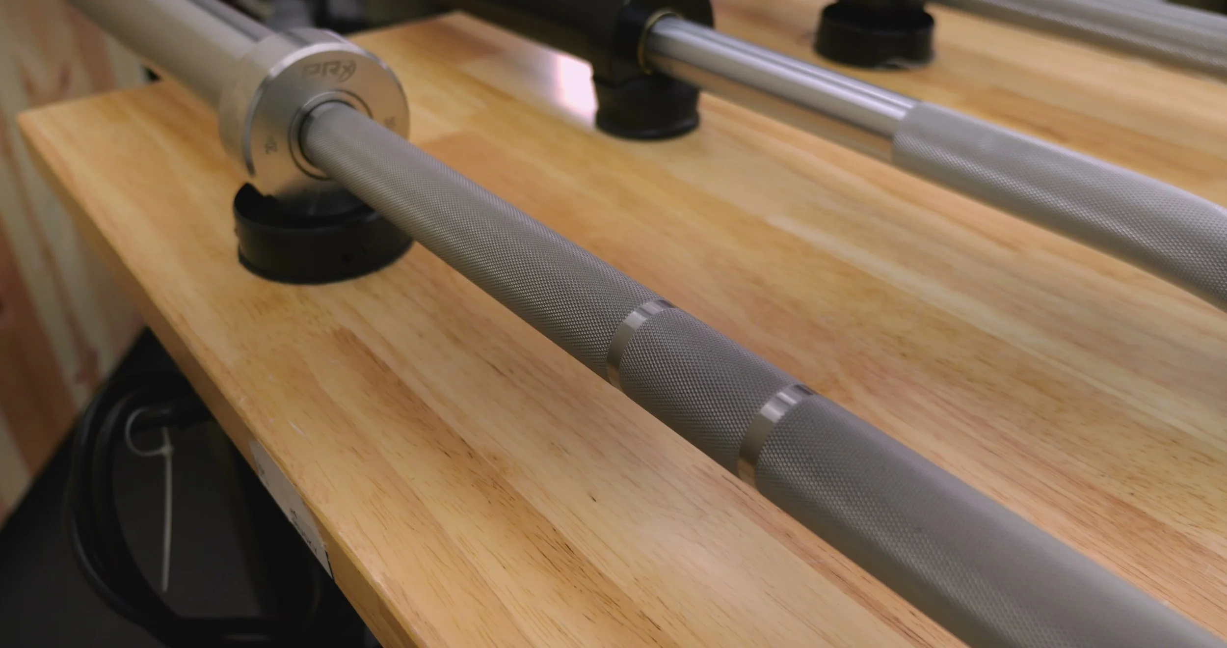 Close-up of the passive volcano knurling and stainless steel finish on the PRx Thresher barbell