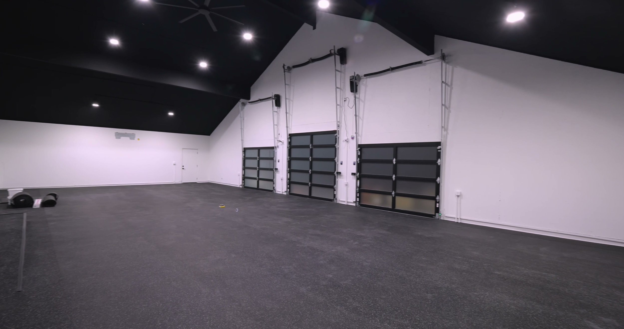 Wide view of the 1,900-square-foot studio featuring the installed HammerClad rolled rubber flooring with 10% gray fleck.