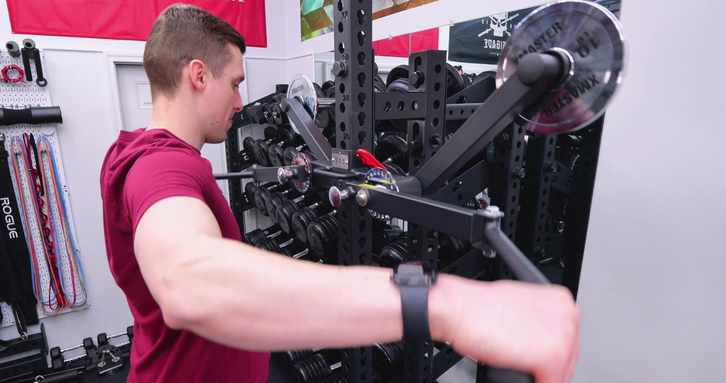 Performing a lateral raise on the Bells of Steel Shoulder Boulder