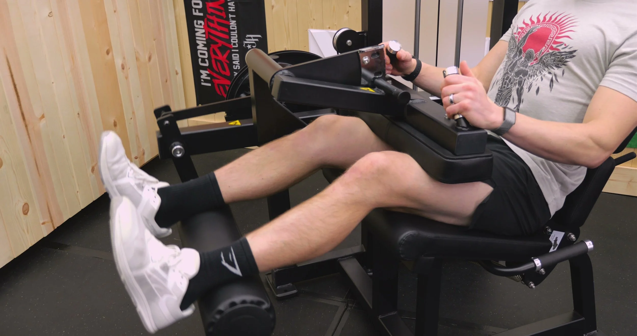 Leg curl configuration with hold-down pad and handles for bracing during curls