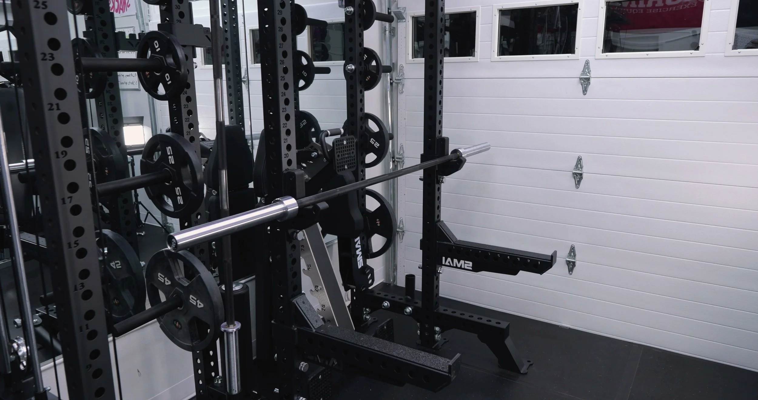 Bare Steel Iron Skull Power Bar and Blue Collar Barbell side by side in a home gym