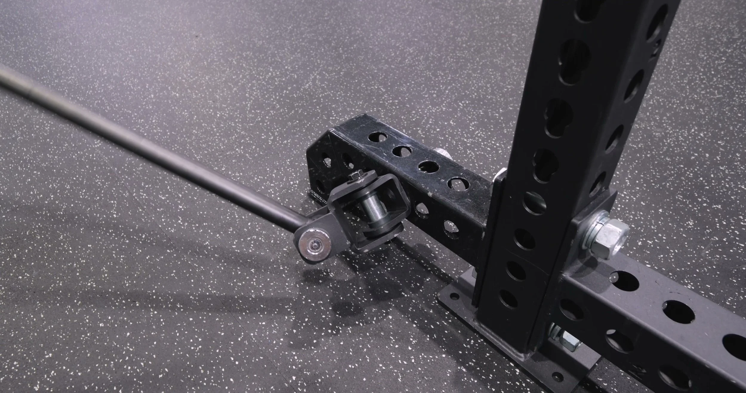 Close-up of the Exponent Edge Landmine Bar rotating rack mount attached to a power rack upright
