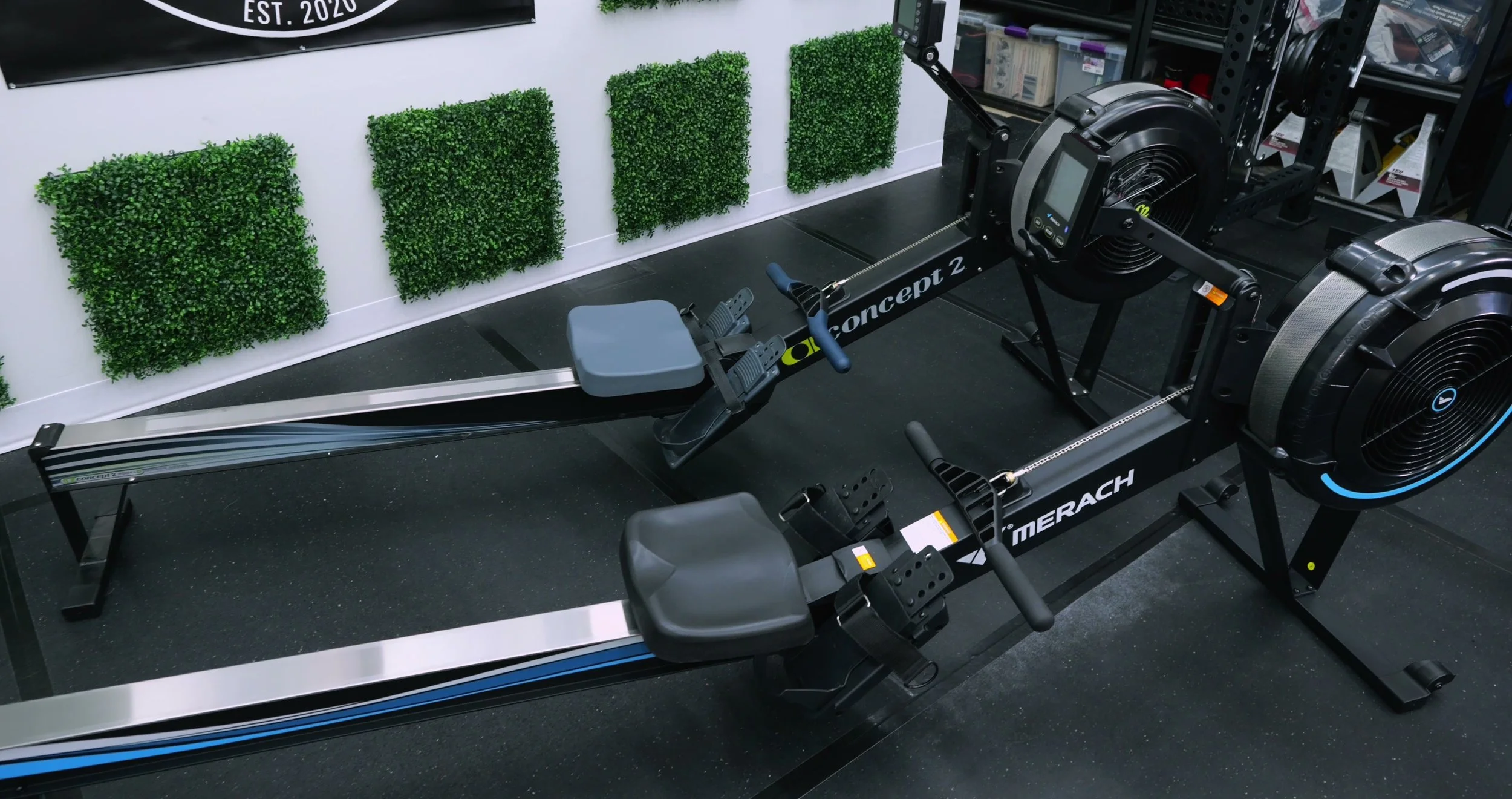 Merach R50 rower positioned next to a Concept2 RowErg for comparison