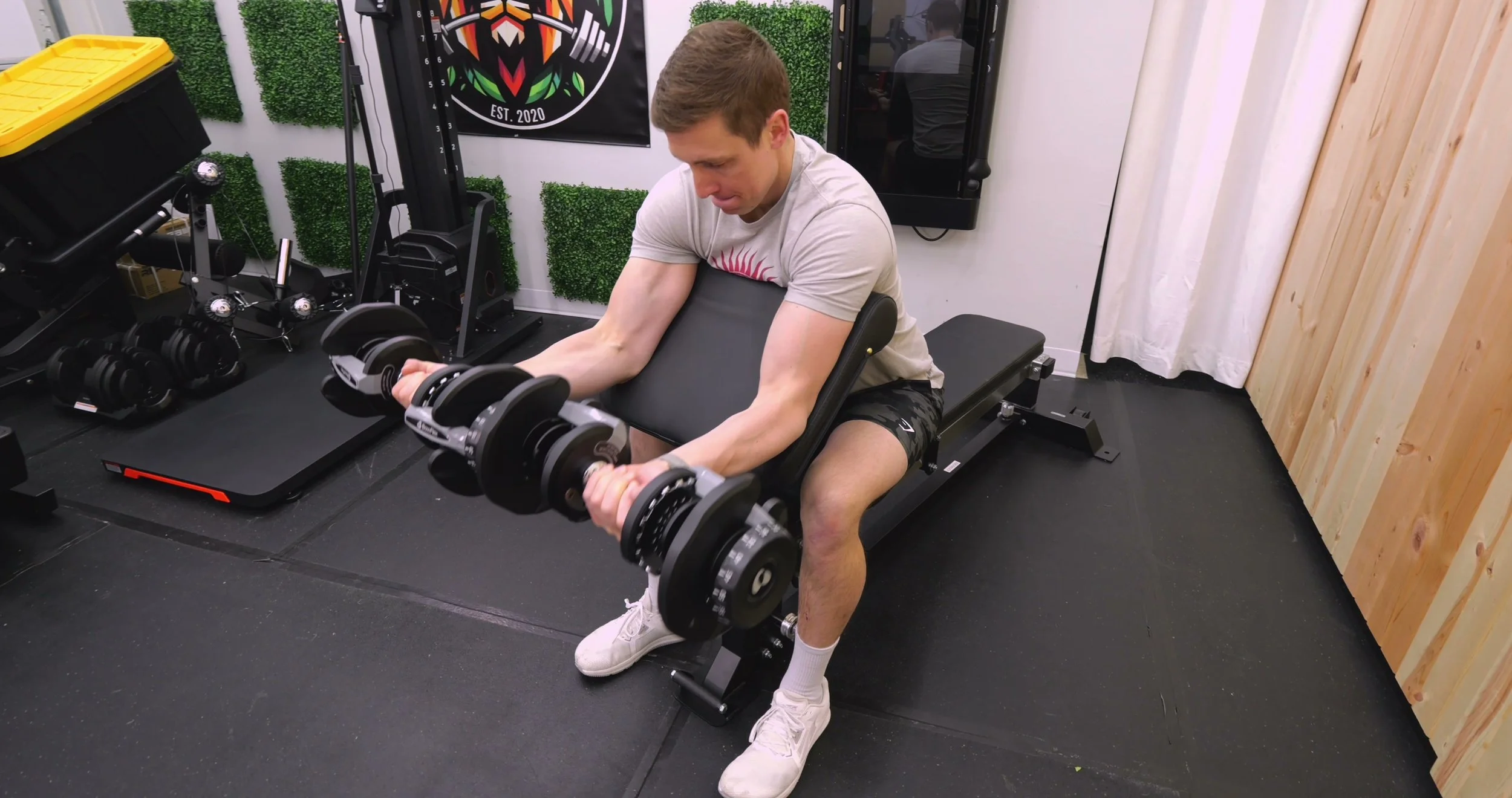 The various attachments included with the Force USA Sliding Bench, including the preacher curl and leg extension