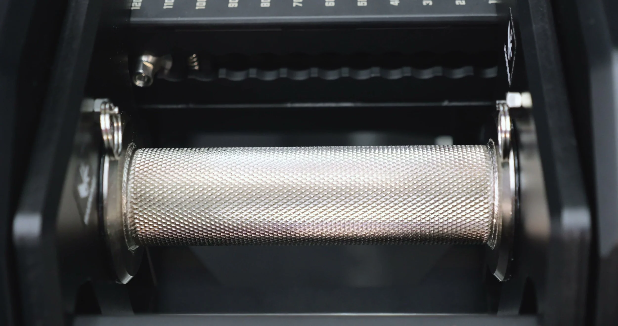 2.5 lb adder weights installed on dumbbell ends for five pound jumps