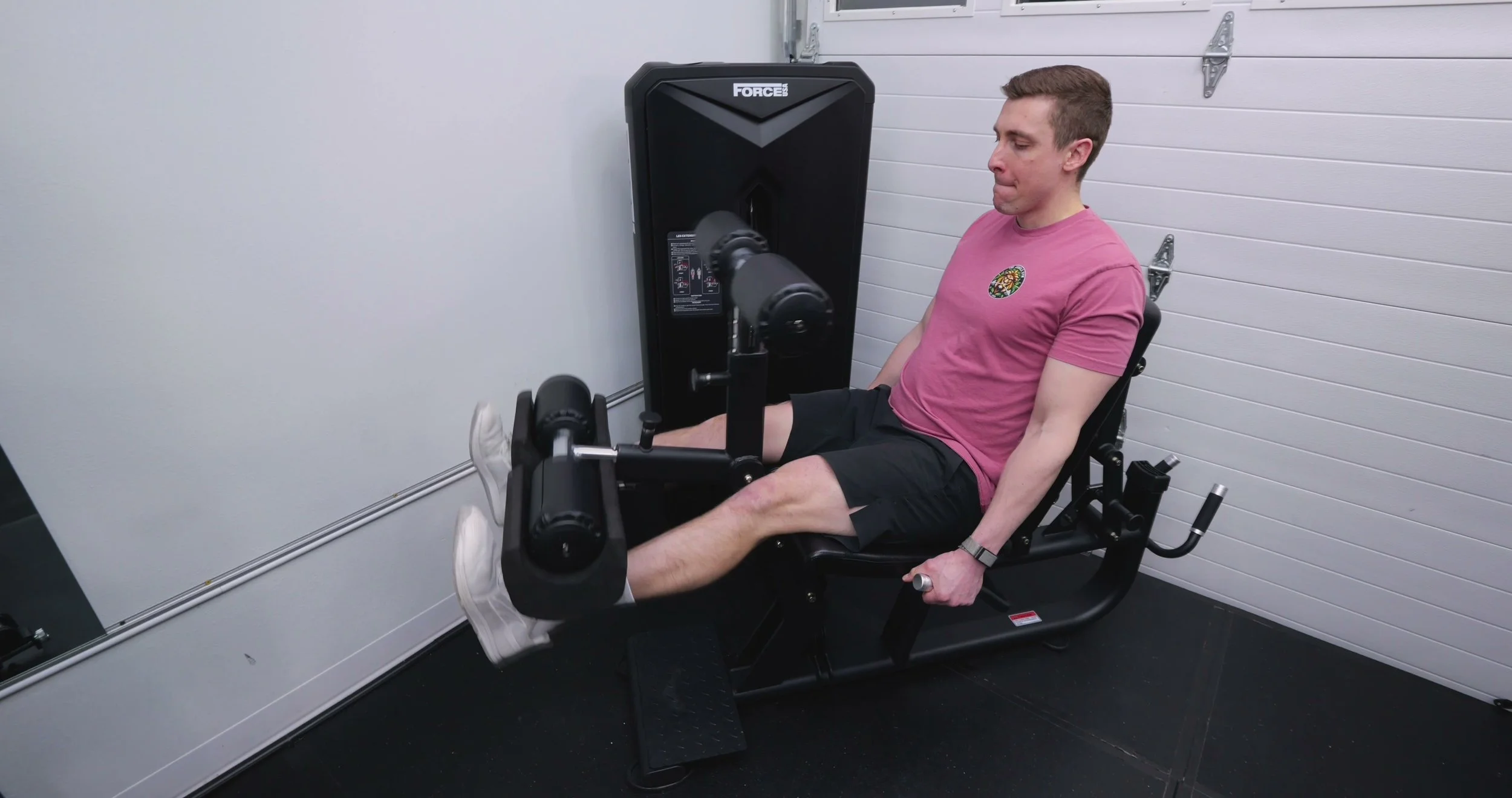 Force USA Solitude Leg Extension and Leg Curl machine in a home gym