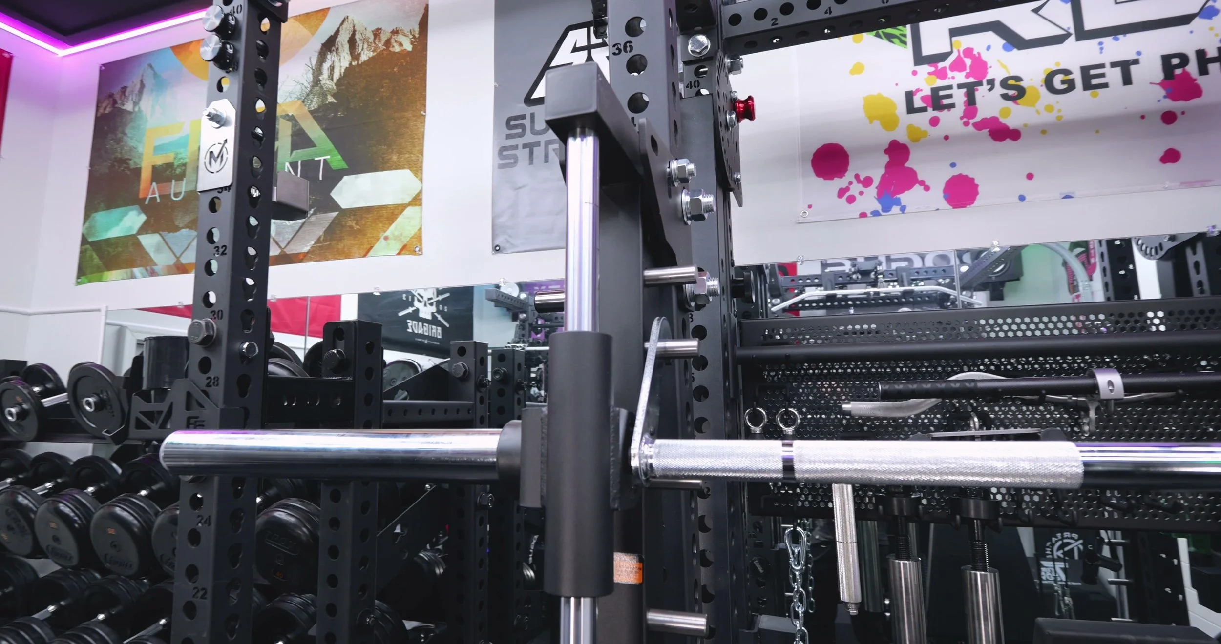 Smith machine latching hooks protruding into rack