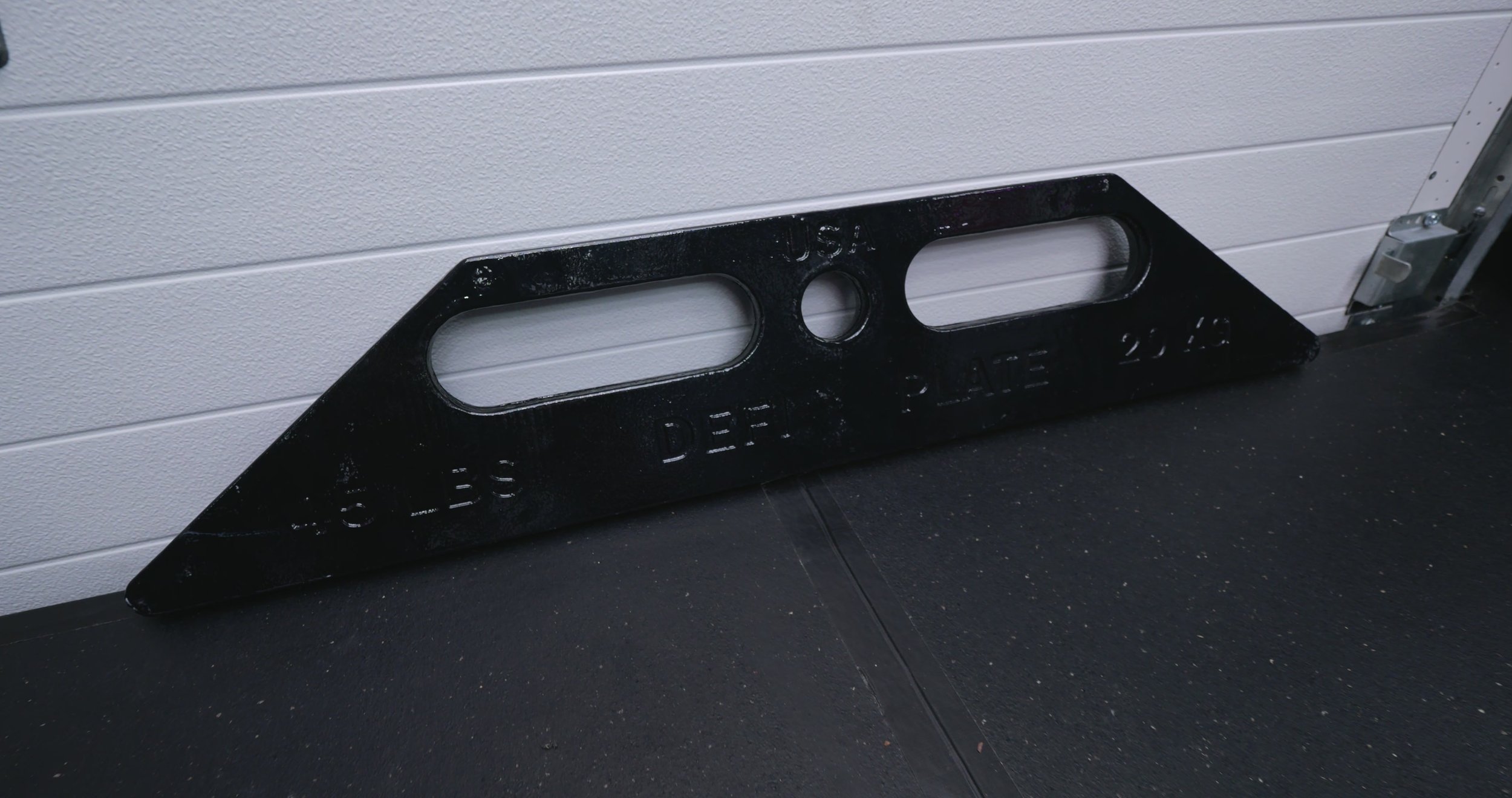 DefiPlates stored upright against a wall, showing non-rolling flat sides