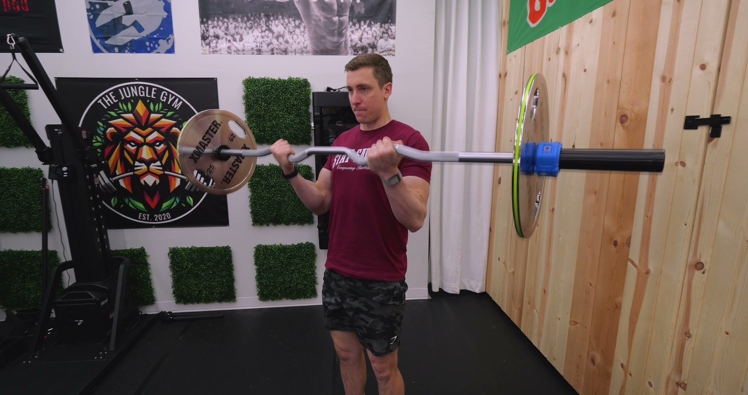 The PRx Hammerhead rackable curl bar resting in the J-cups of a power rack