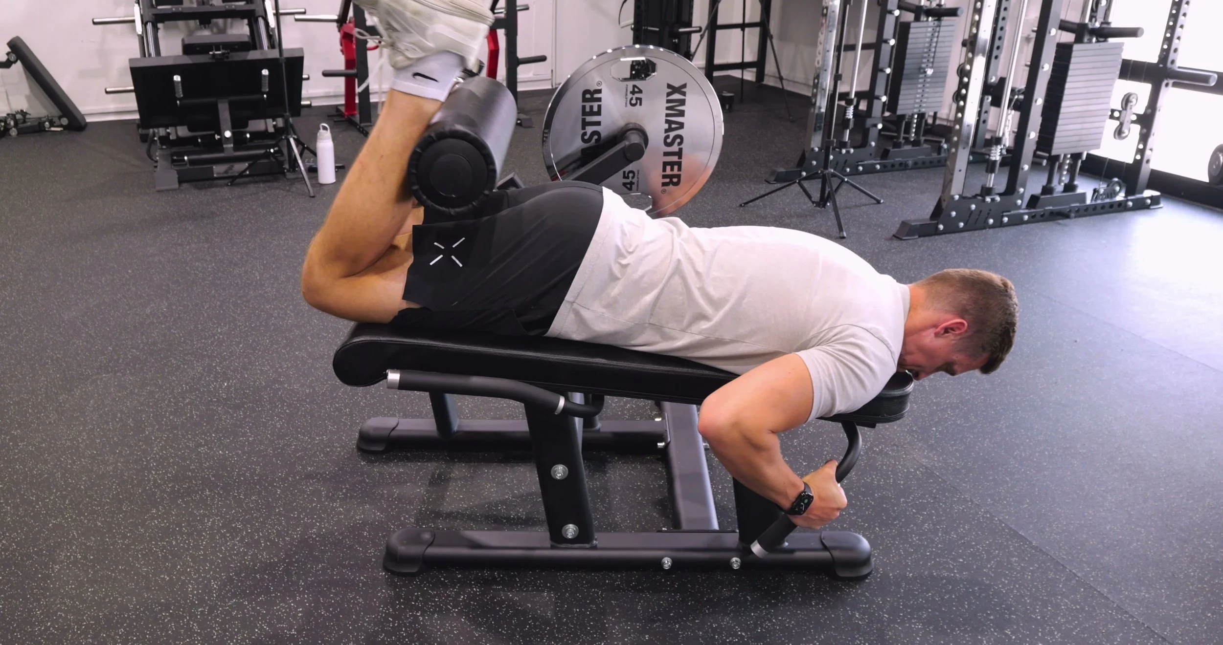 Michael demonstrating the prone hamstring curl on the Legion Fitness LELC