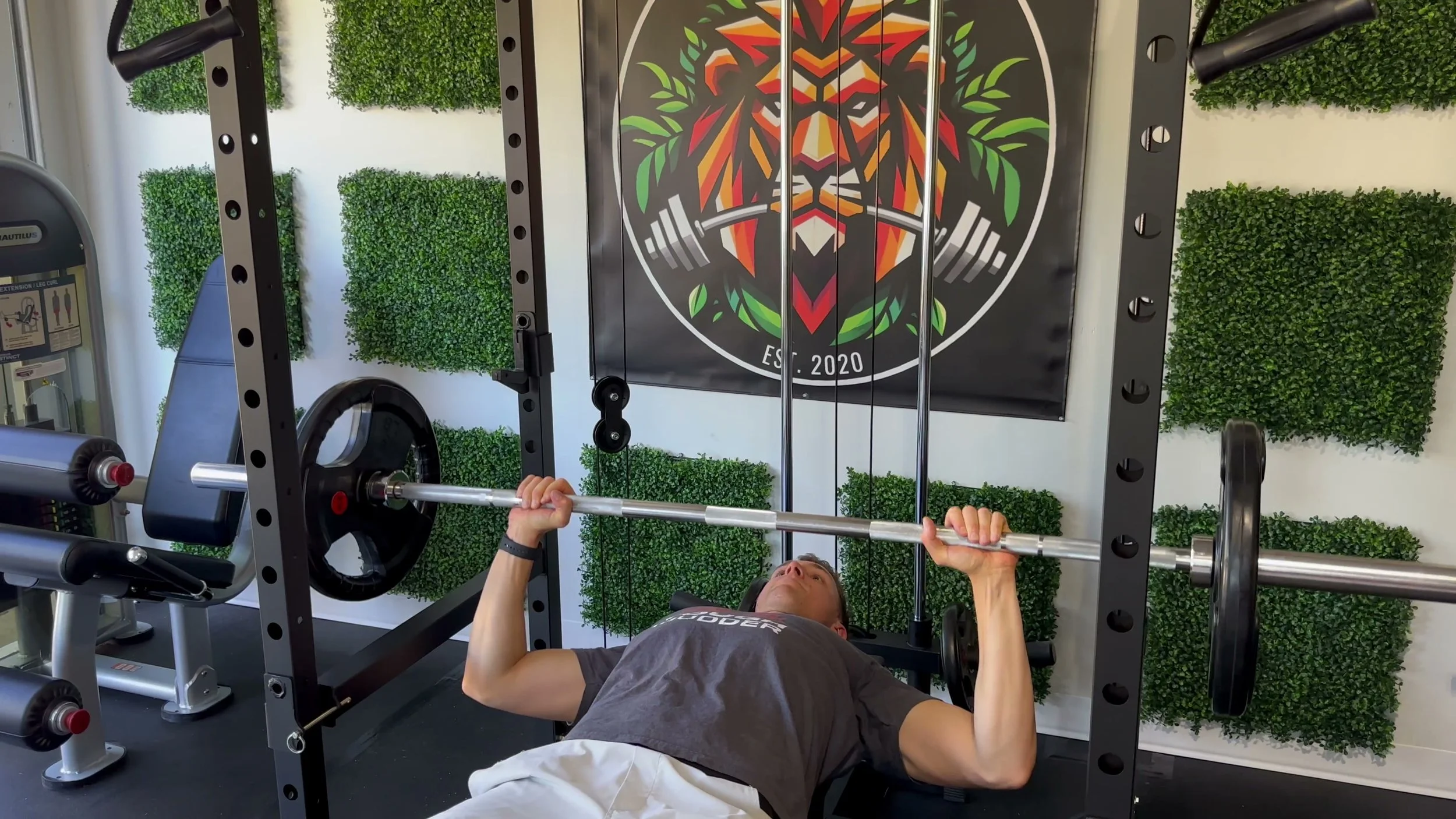 flip down safety spotters installed inside rack with detent pin visible