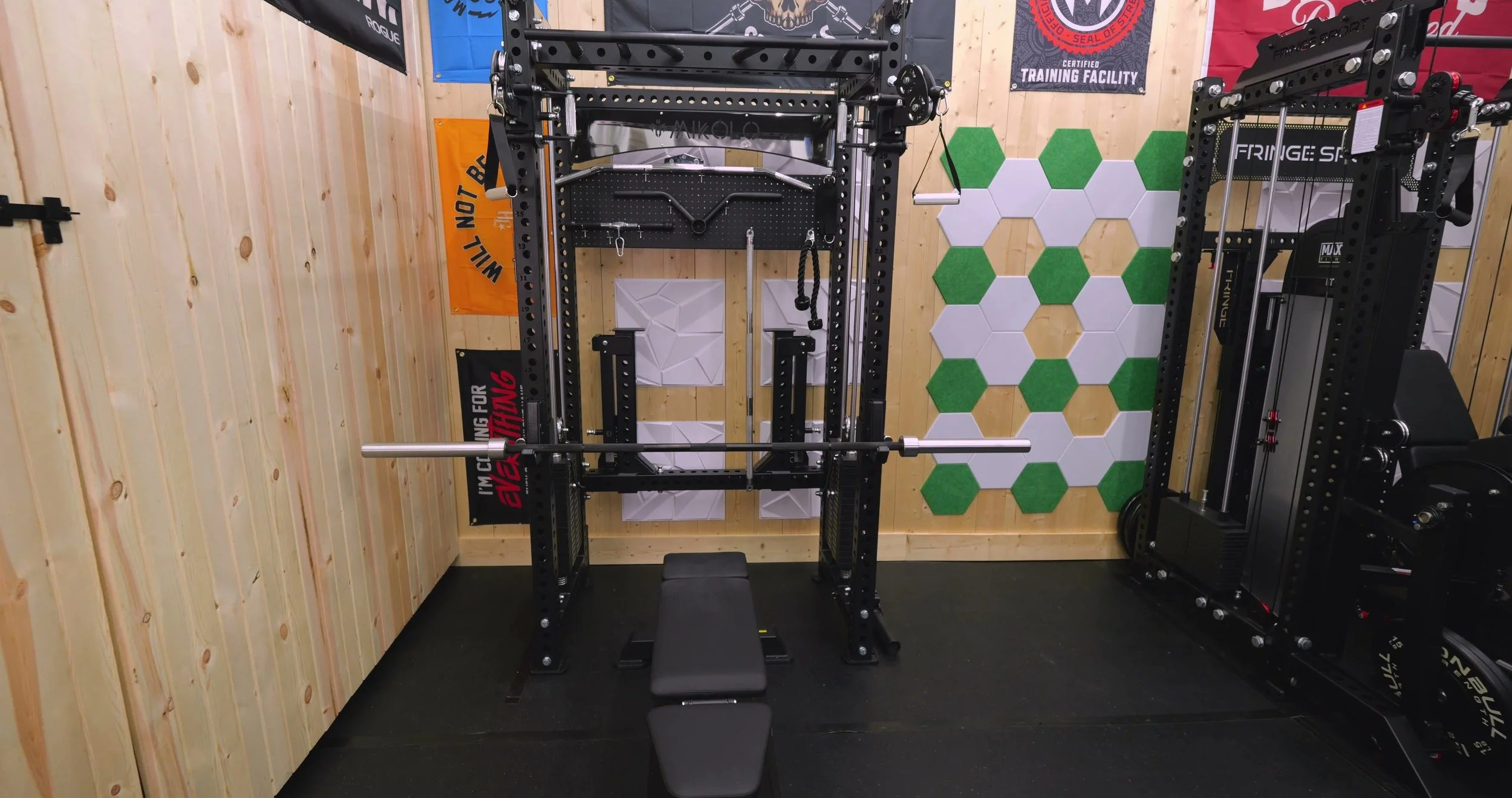 Rear view of the Mikolo Anubis 2.0 Elite showing back storage crossmember, compact footprint, and stored spotter arms