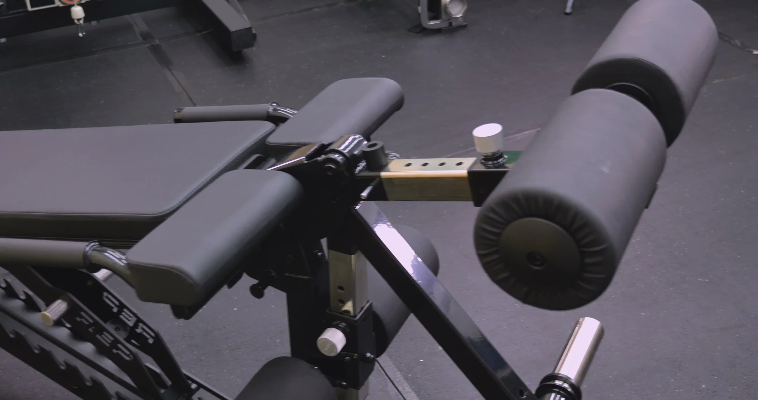 side view of rep leg extension attachment mounted to bench