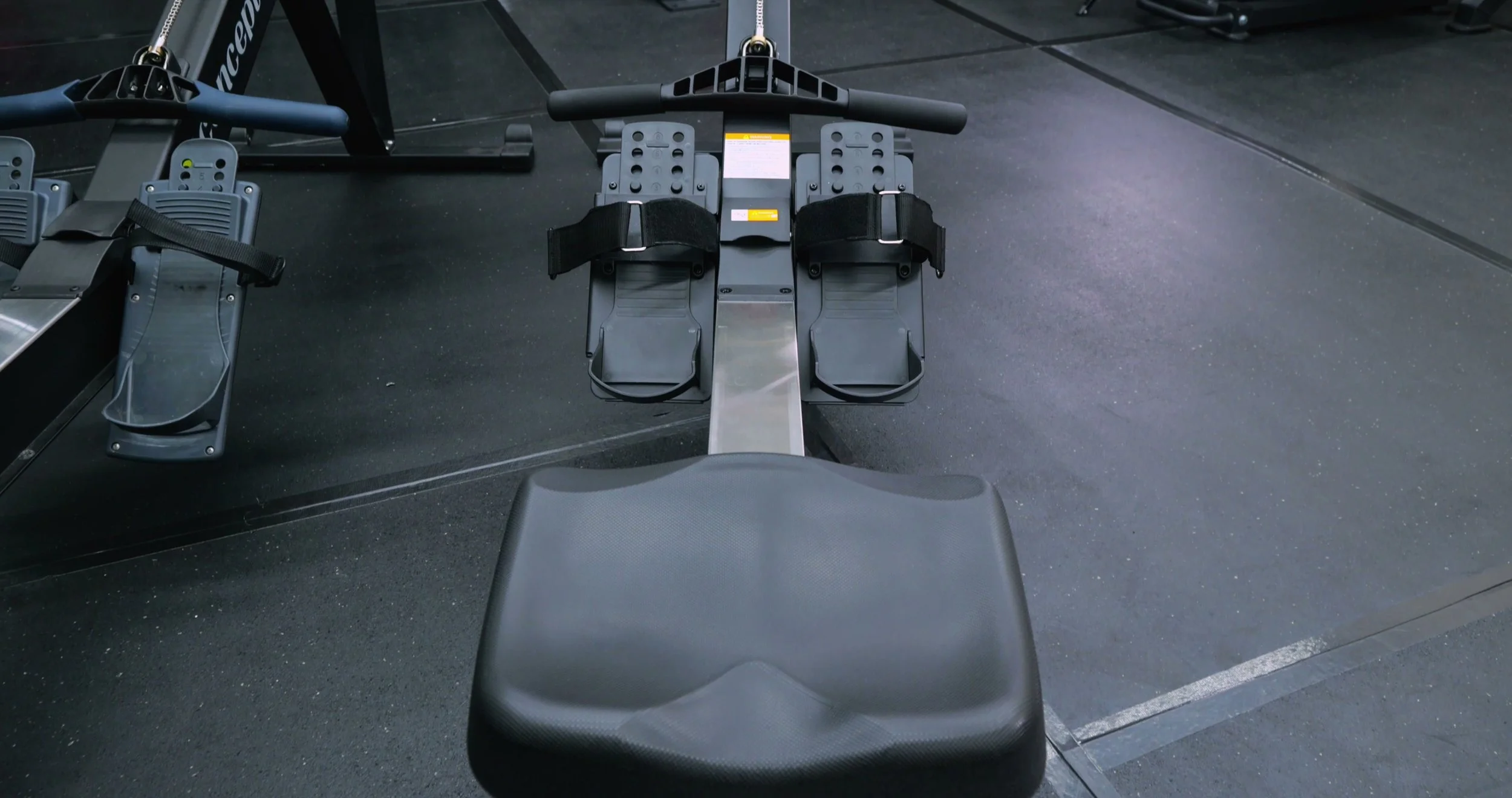 Close-up of Merach R50 padded seat on the rail