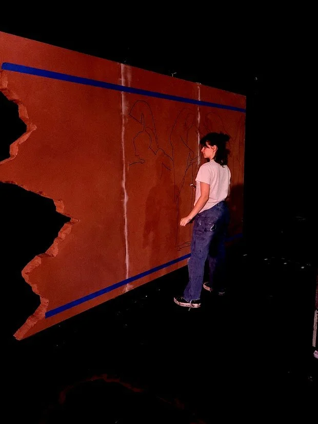 Demonstrating to the scenic artists how to use a projector and trace out the pottery walls