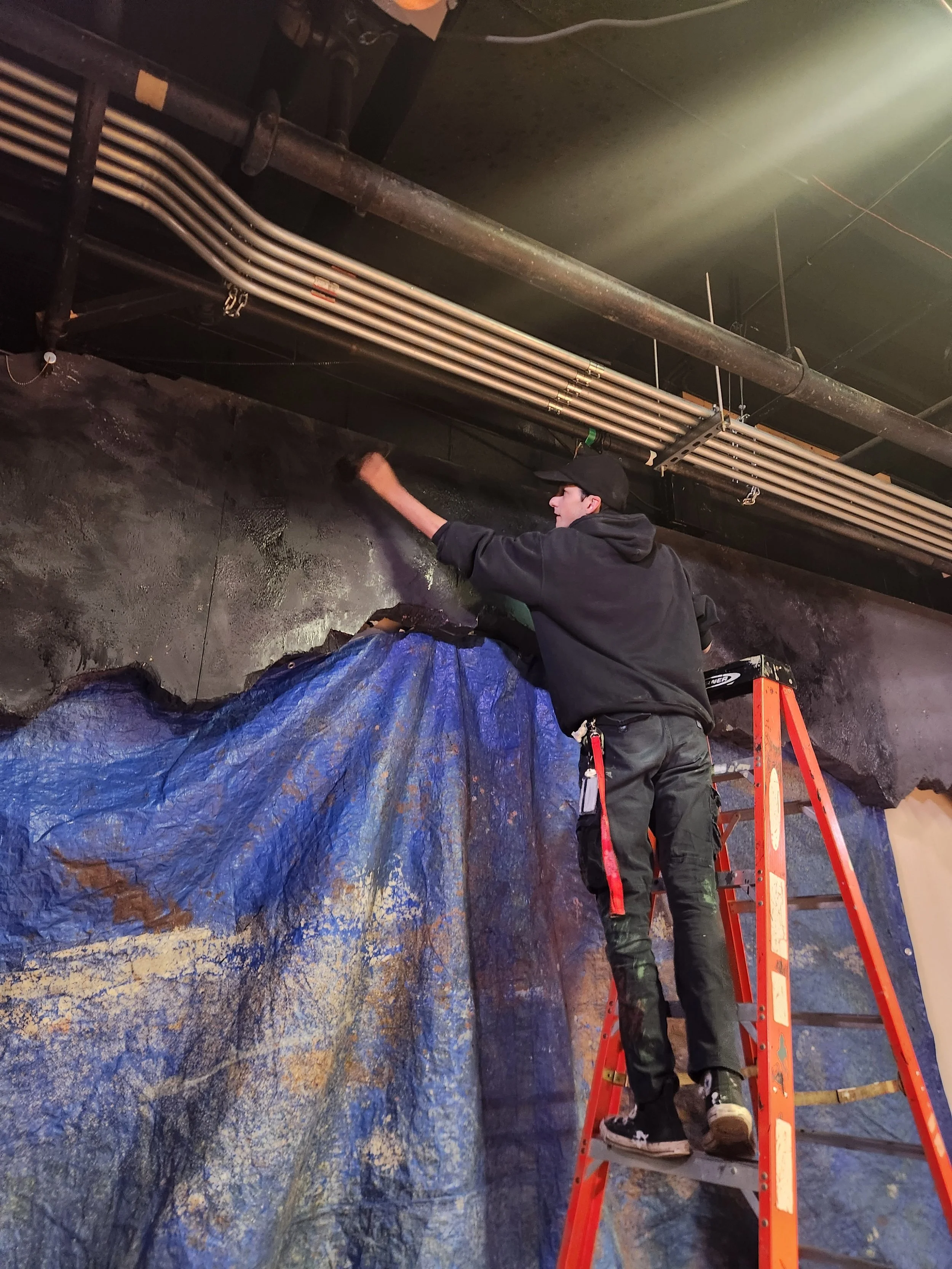 Chris adding shadow and depth to the back walls