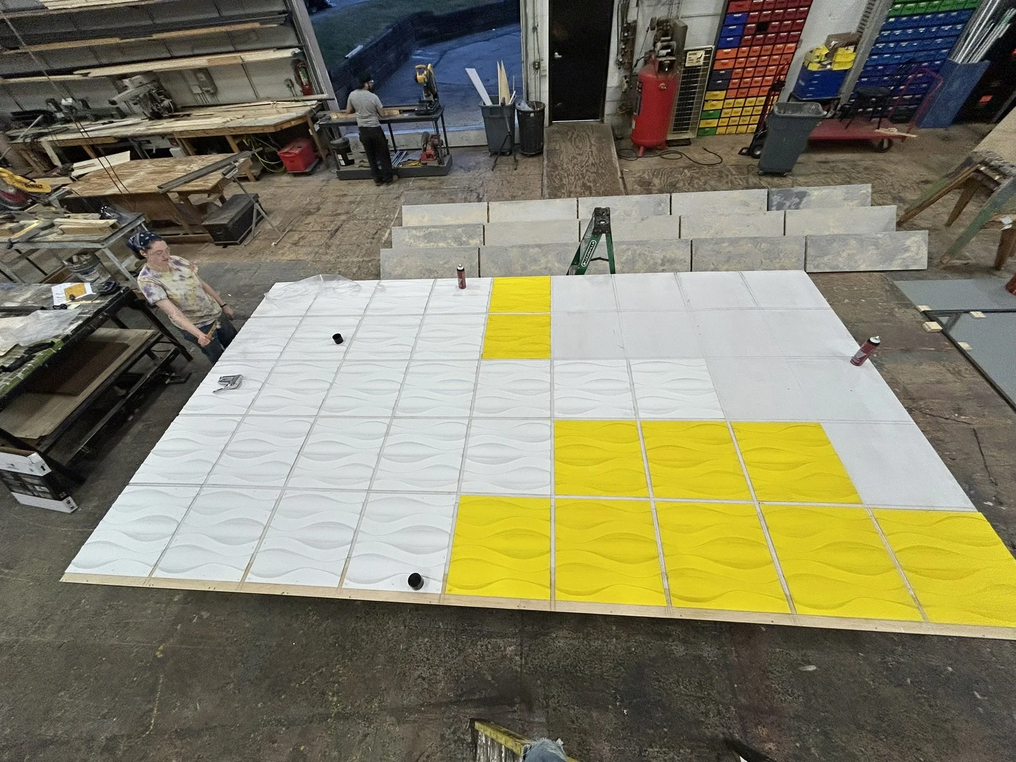 Gridding out and painting process photo of the UGC Wall