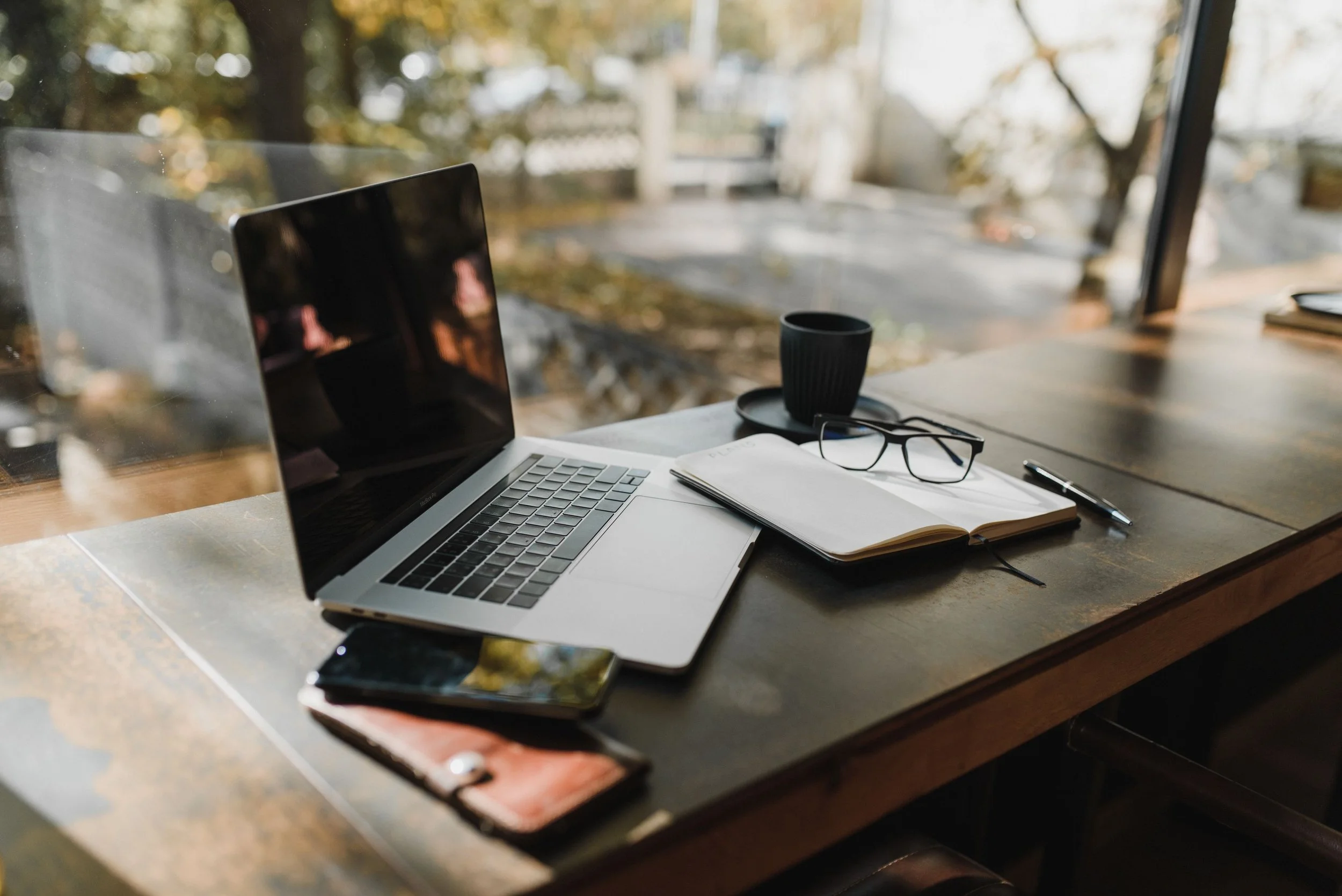 desk with laptop and coffee and notepad virtual assistant desk