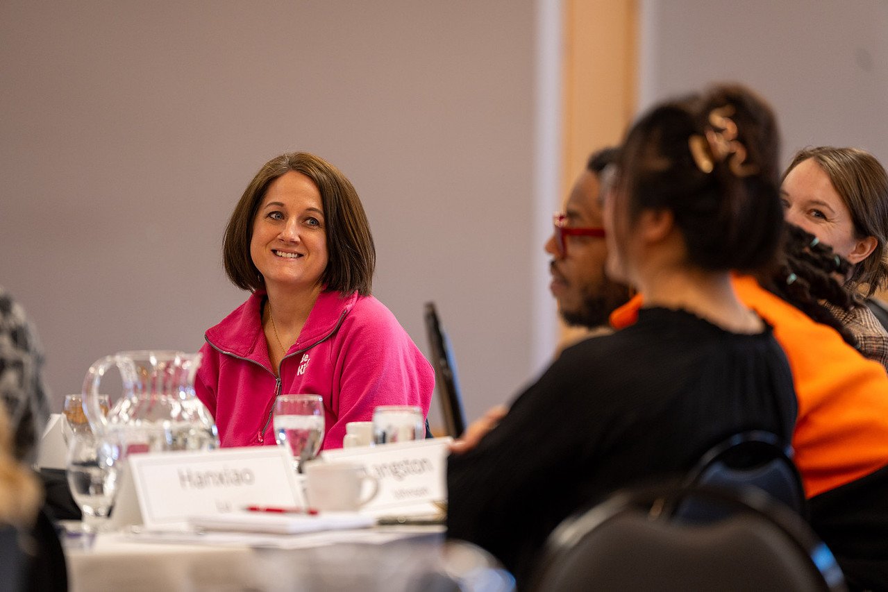 Woman smiling at a group of people
