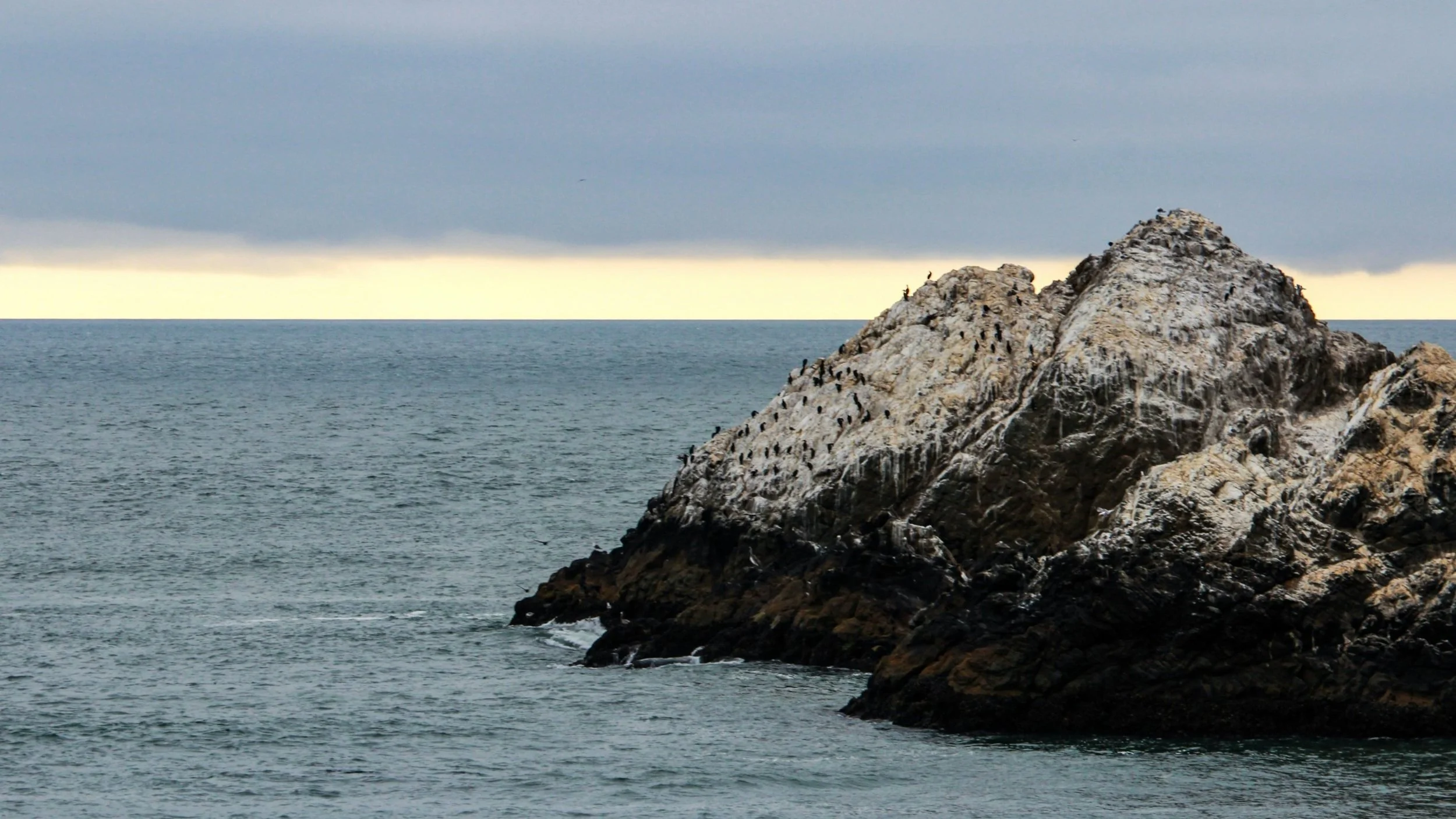 A rocky outcropping near the ocean is seen here.