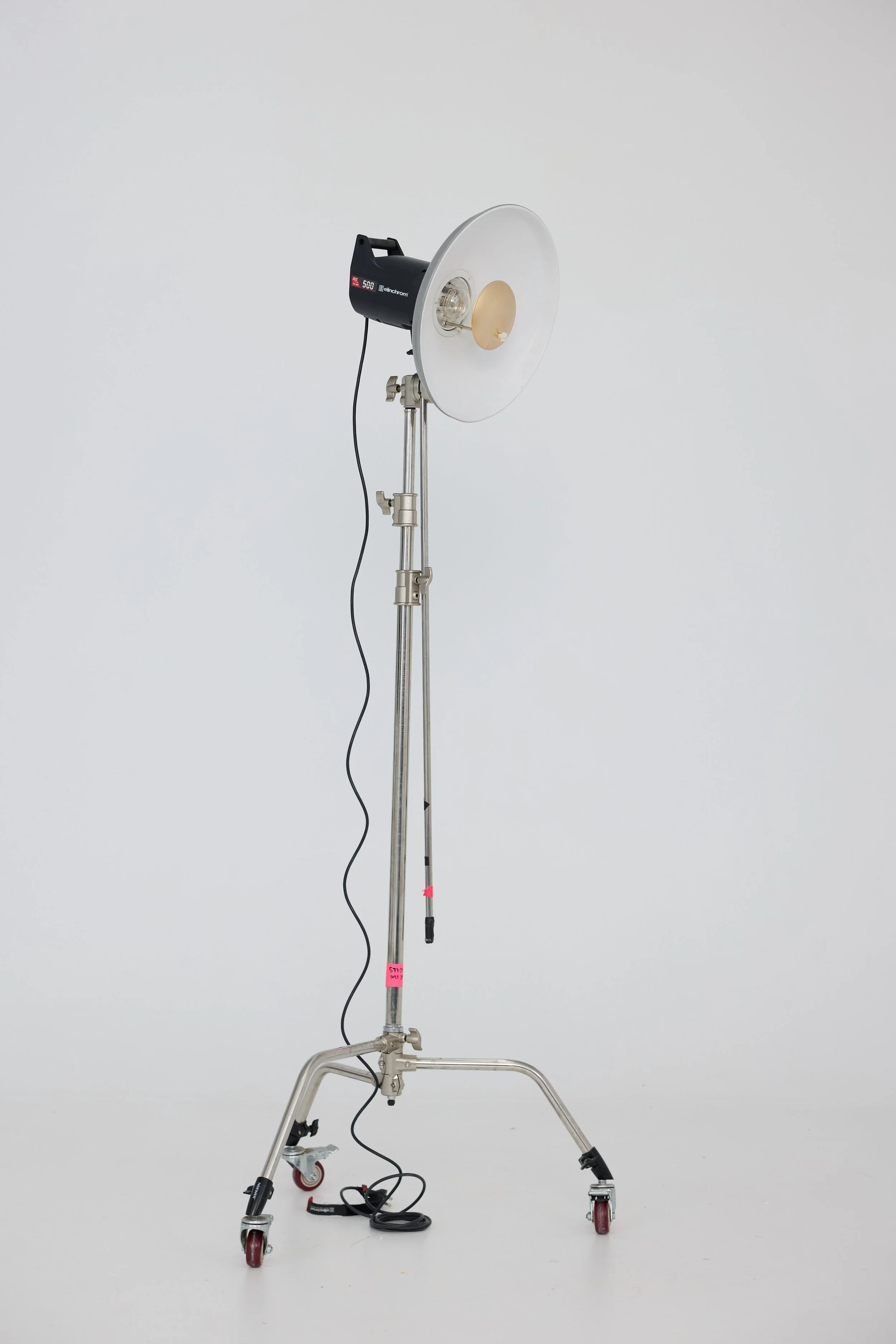 Photograph of a professional studio light on a mobile stand against a plain white background.