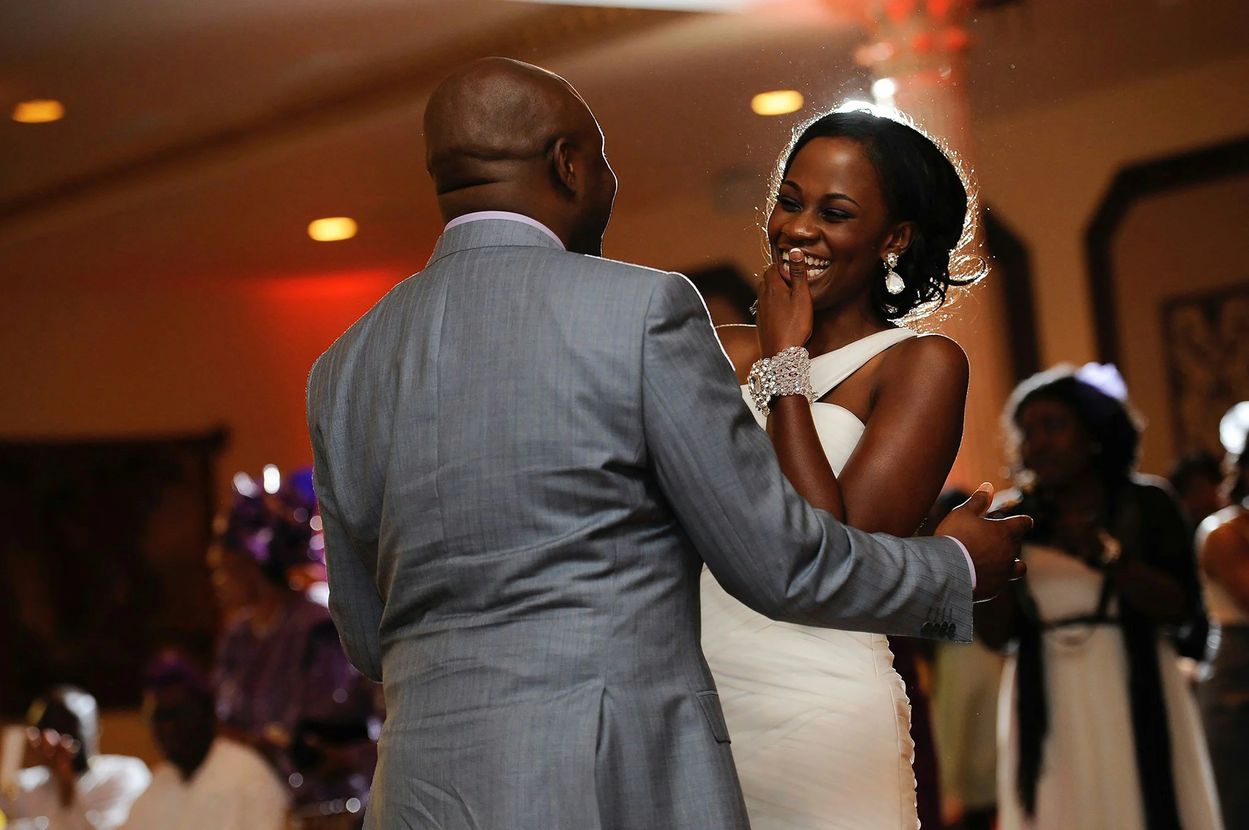 A couple dancing closely at their wedding reception.
