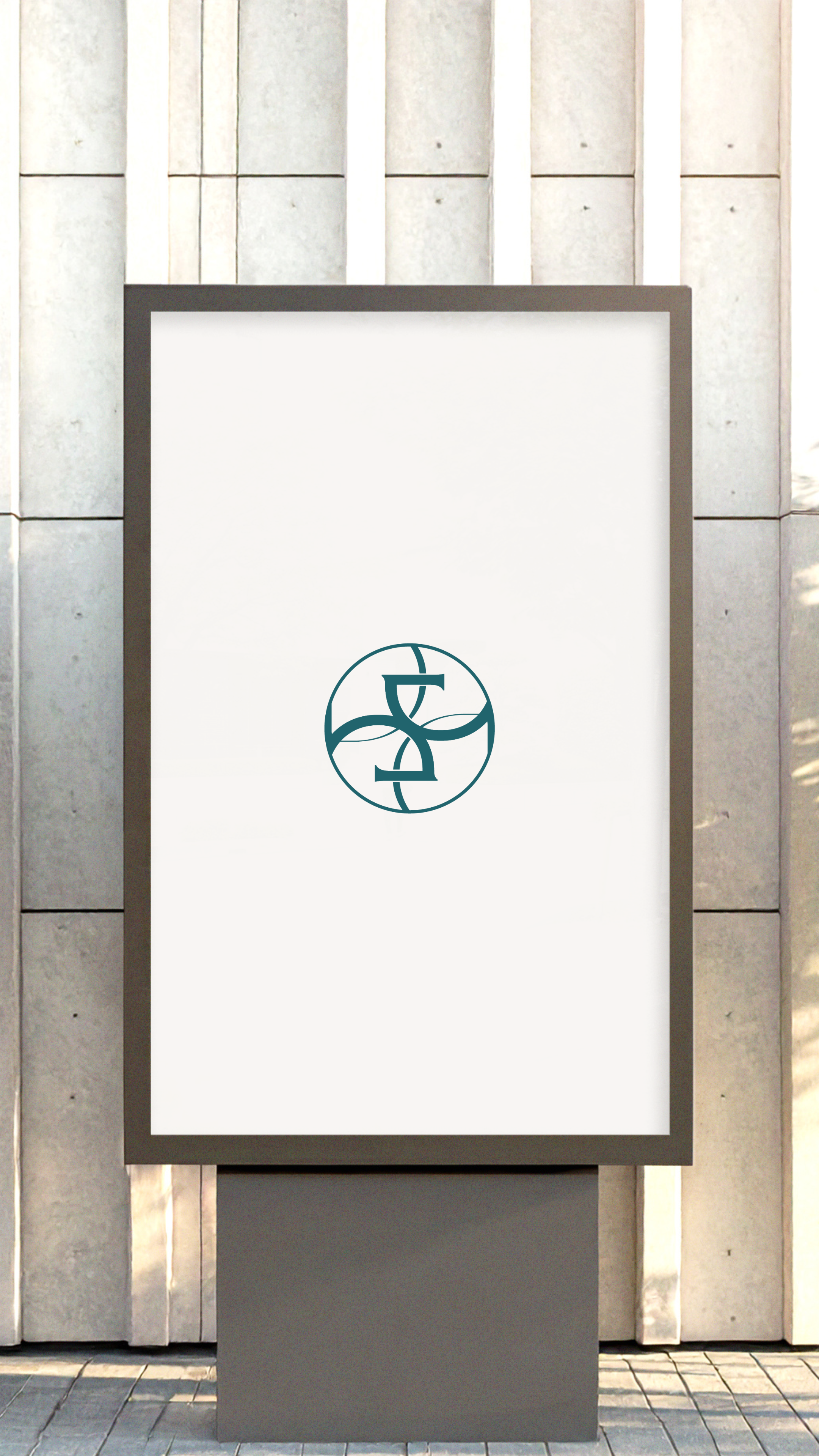 Empty advertisement stand with a logo of a circle divided into four sections and a stylised letter 'D' and 'G' in the centre, against a stone wall background.