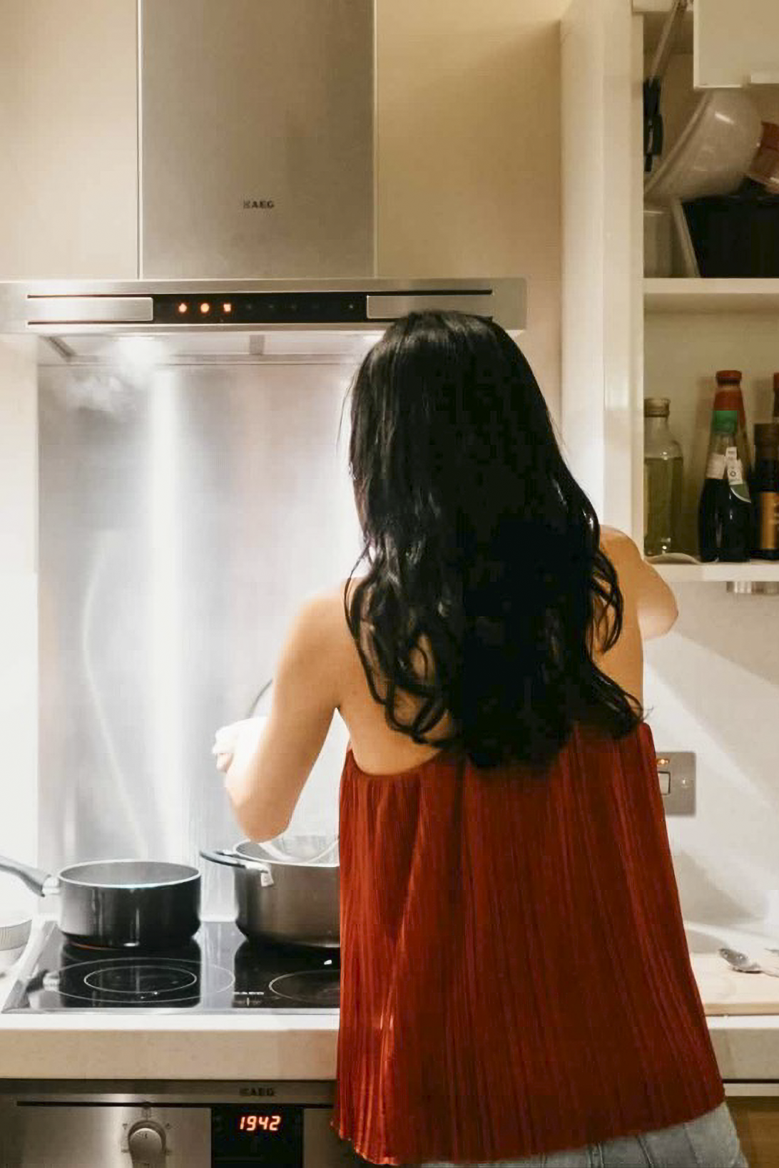 Rebecca Lim cooking at a stove, steam rising from a pot