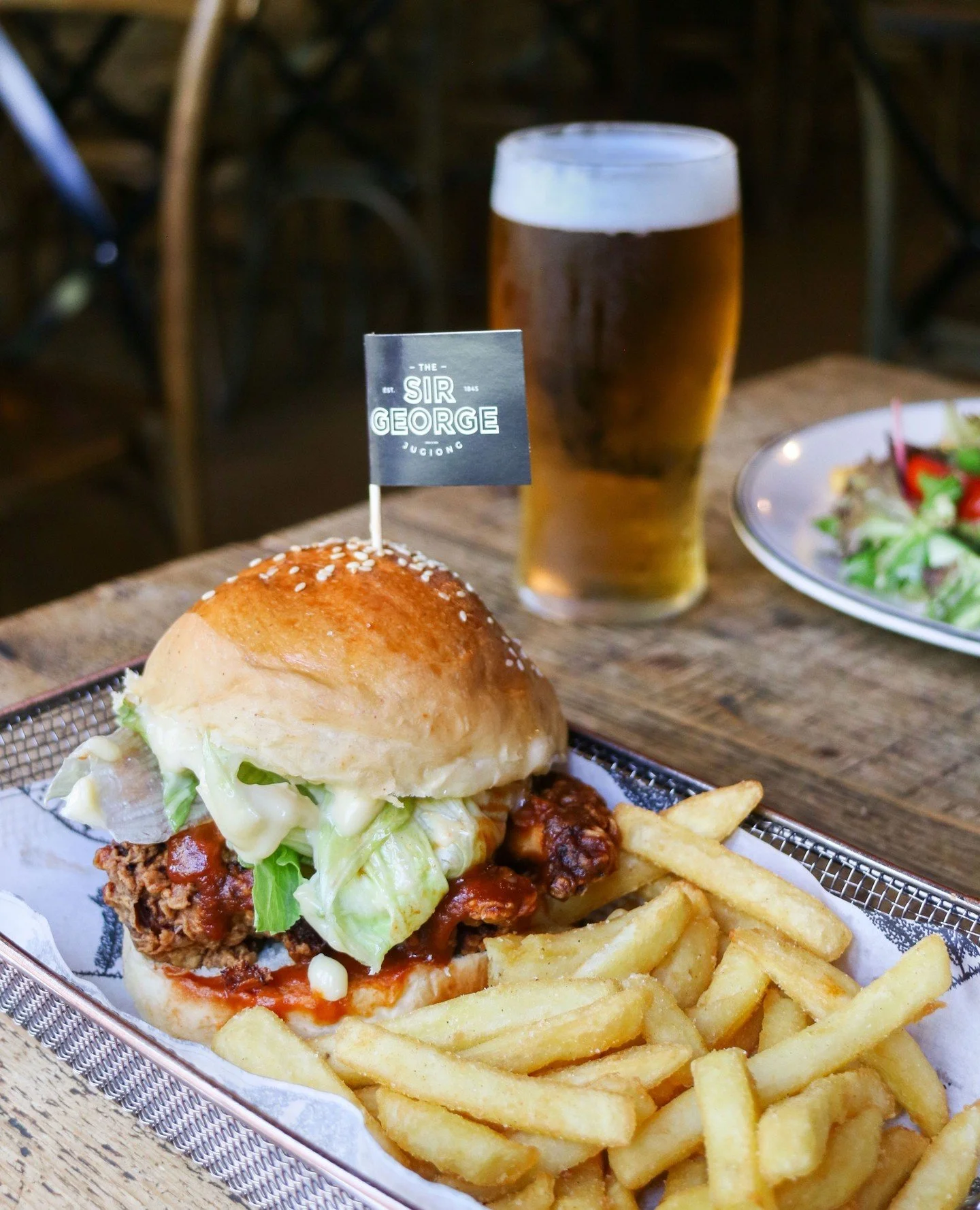 Our famous Fried Chicken Burger &bull;  lettuce, pickle, buffalo sauce, aioli, milk bun, chips⁠
⁠
Book a table via the link in bio