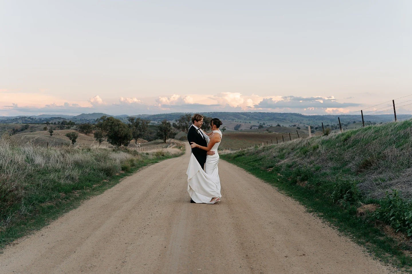 Mikaela and Ben in the rolling hills of Jugiong - captured beautifully by @olt.media 🩷⁠
⁠
⁠
⁠
⁠
Bride: @mikkivialshaw⁠
Groom: @ben.georgas⁠
Venue: @thesirgeorge⁠
Dress: @kyhabride⁠
Suit: @institchu⁠
⁠
#TheSirGeorgeWeddings #WeddingsAtTheSirGeorge #J