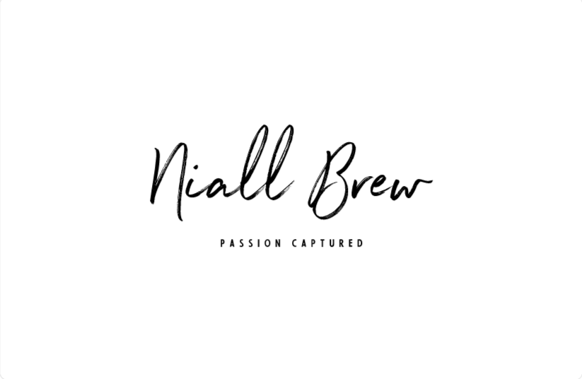 Minimalist white background with black handwritten-style text that reads 'Nial Brew' and smaller text below that says 'Passion Captured'.