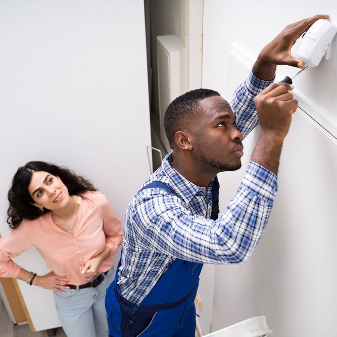 smart security technician troubleshoots a motion sensor